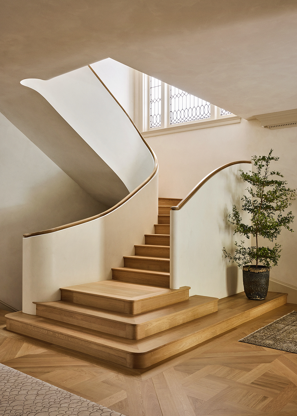 A view of the new interior staircase in a Georgian-style home, showing its architectural detailing and connection to the surrounding interior.
