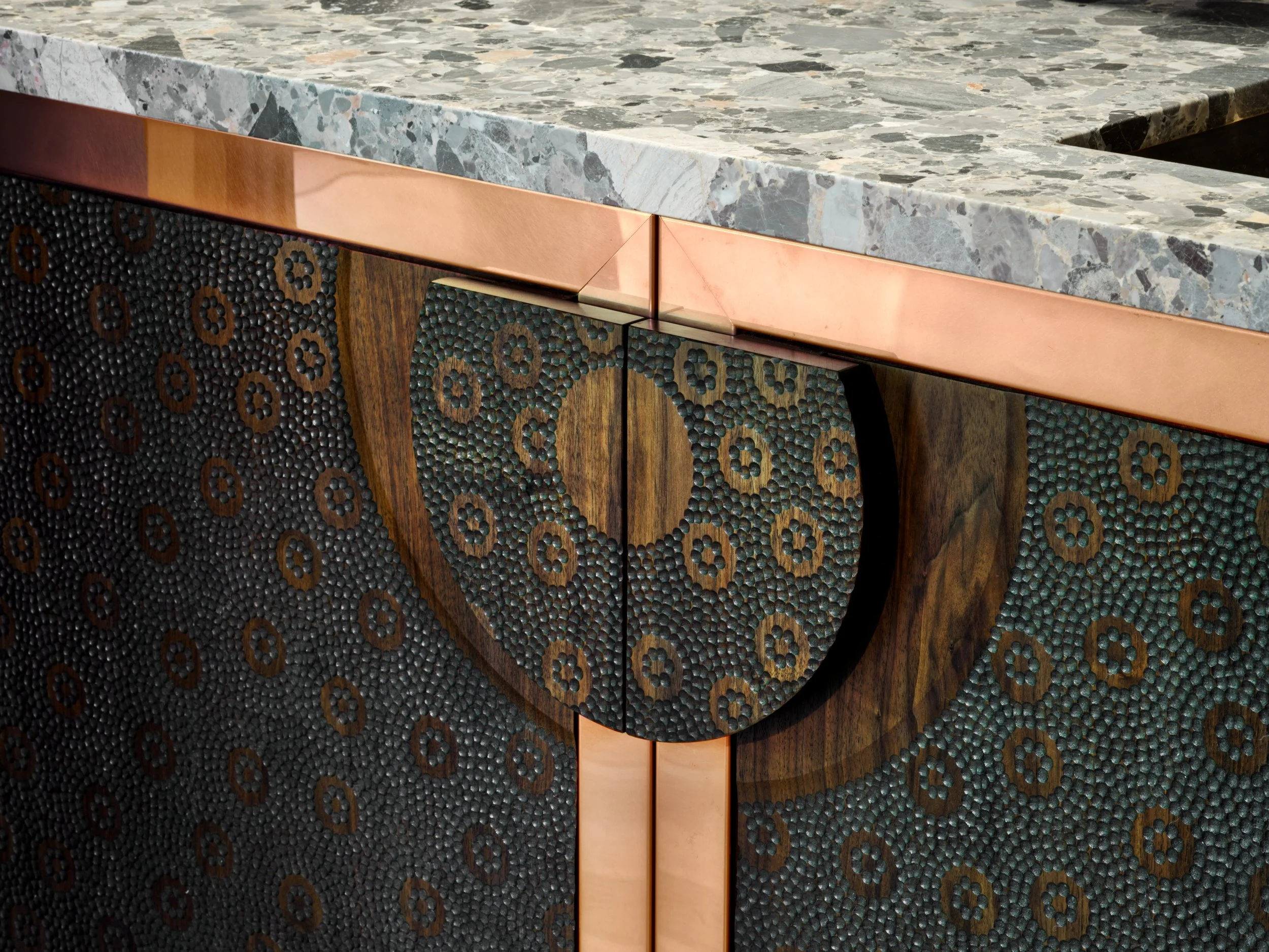 Close-up of intricate cabinet doors featuring a detailed circular geometric design.