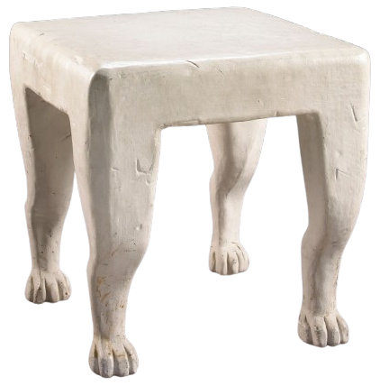 Sculptural white table with a thick rectangular top and four legs shaped like animal legs with feet.