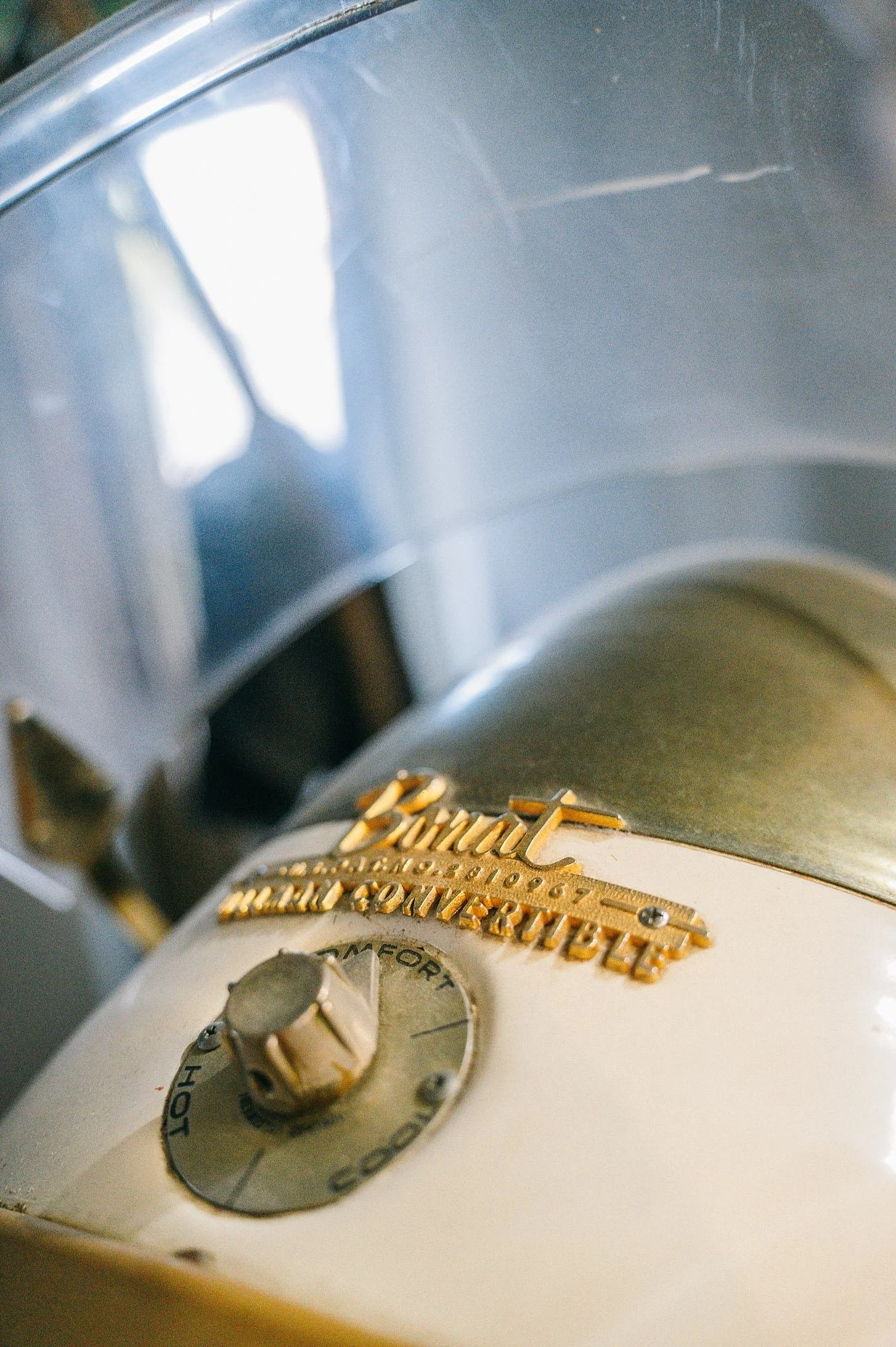 Close-up photo of a vintage kitchen timer with a metal face and gold lettering that reads 'Cookwell'.