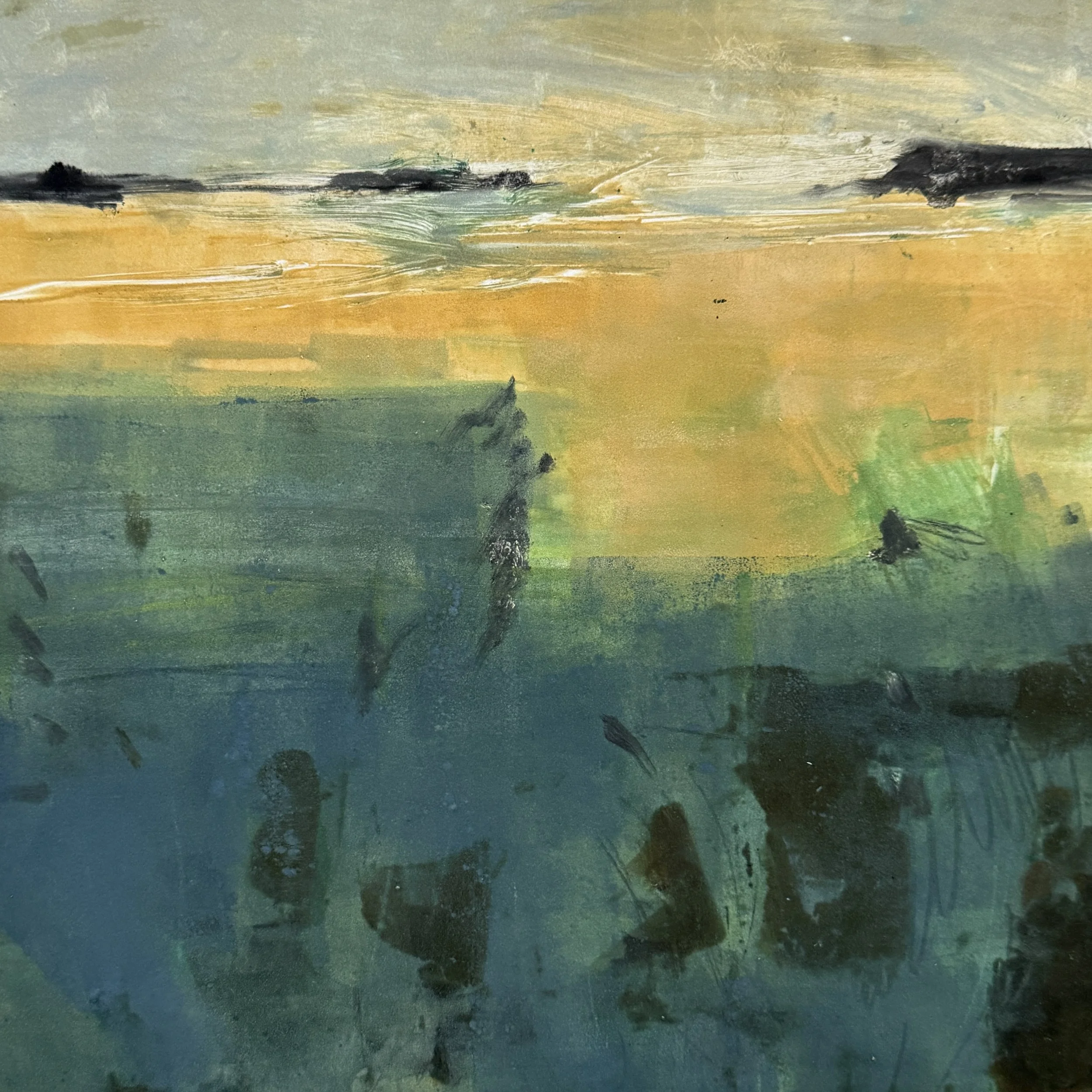 Close-up view of an abstract watercolor painting with horizontal streaks of green, blue, and yellow, and darker accents.