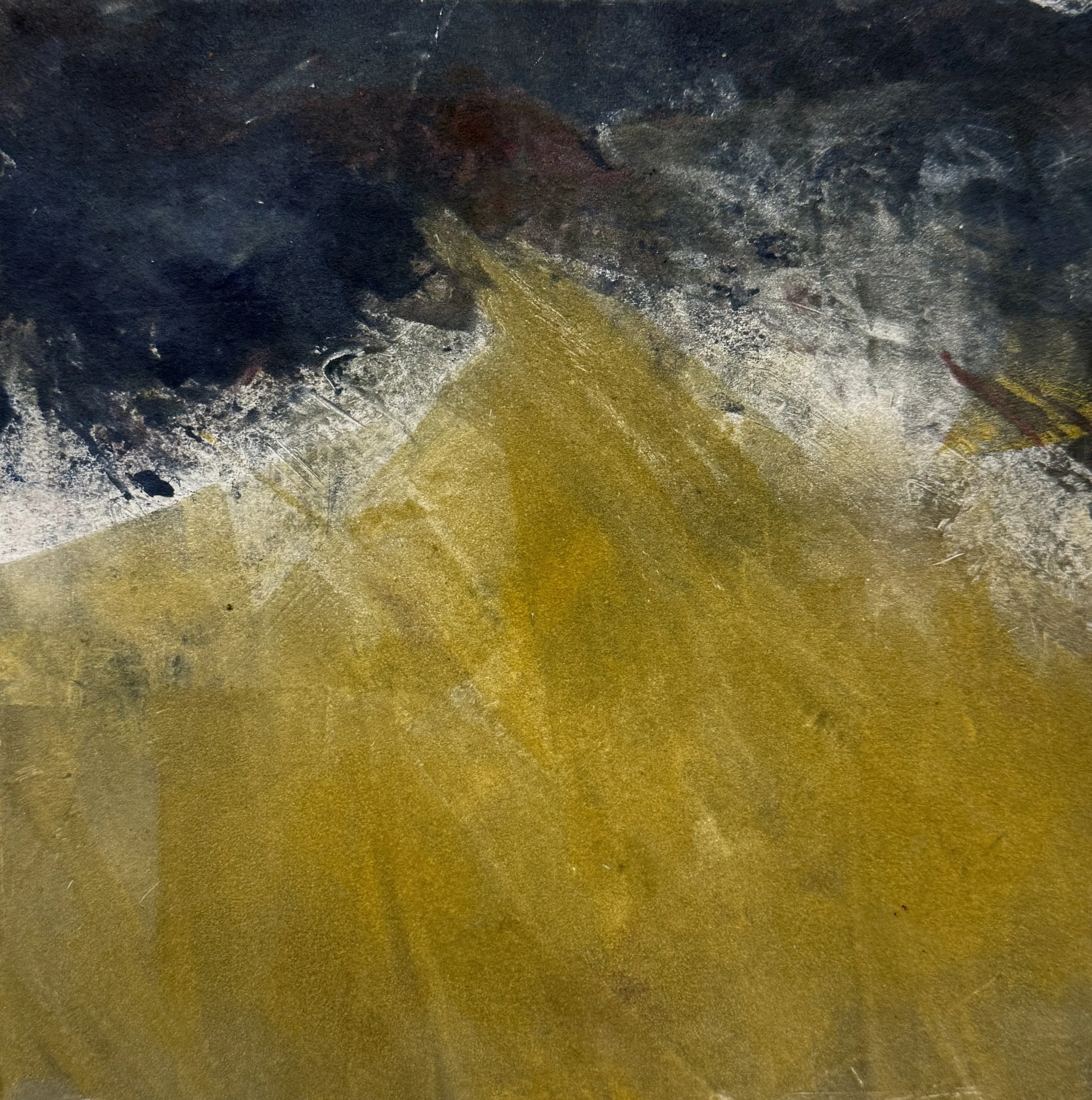 Close-up of a textured surface with dark and metallic colors, showing a mix of black, gray, gold, and some reddish hues, with visible scratches and worn areas.
