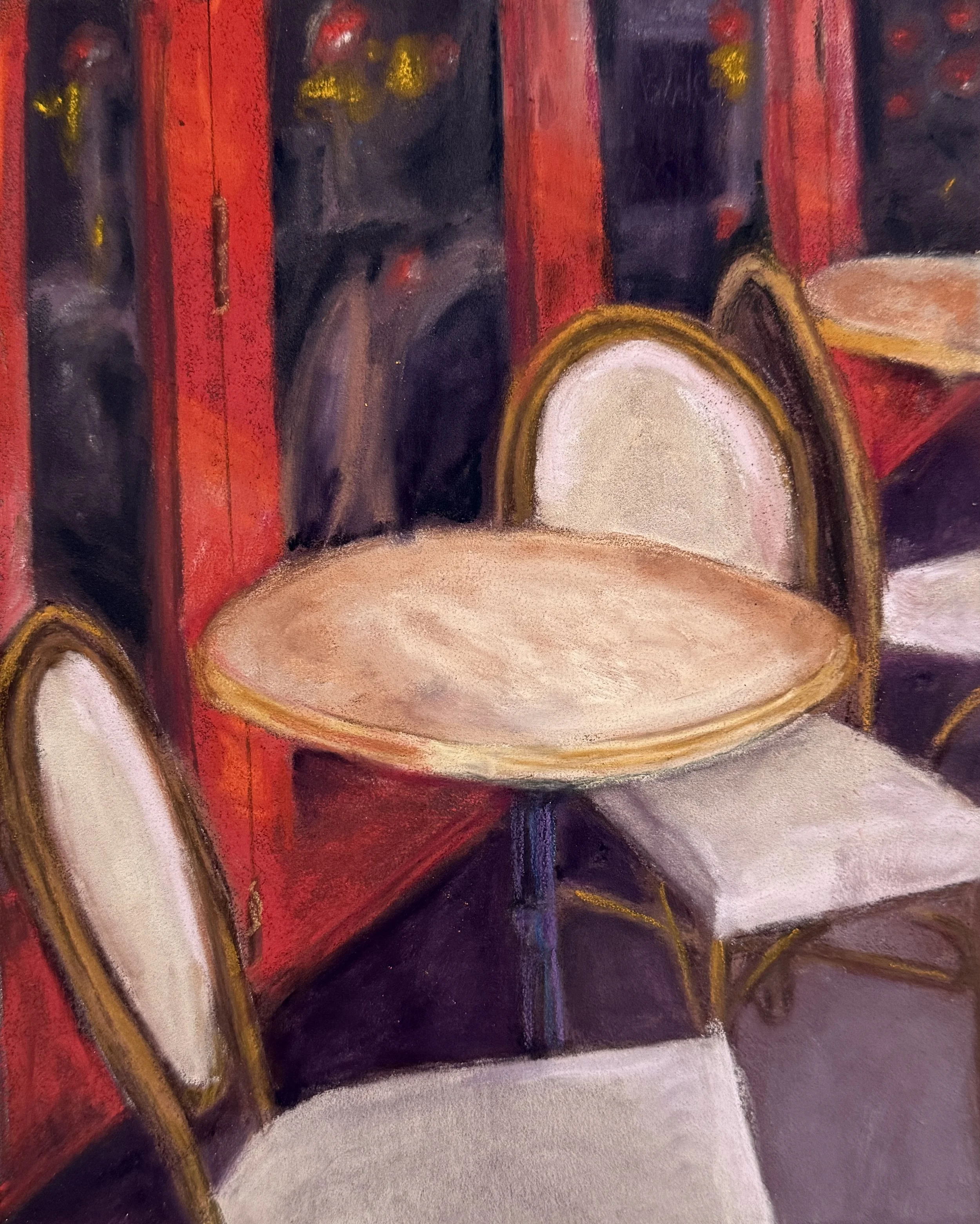 Close-up of a painting featuring a red and black background with abstract shapes, a white oval shape, and decorative yellow accents.