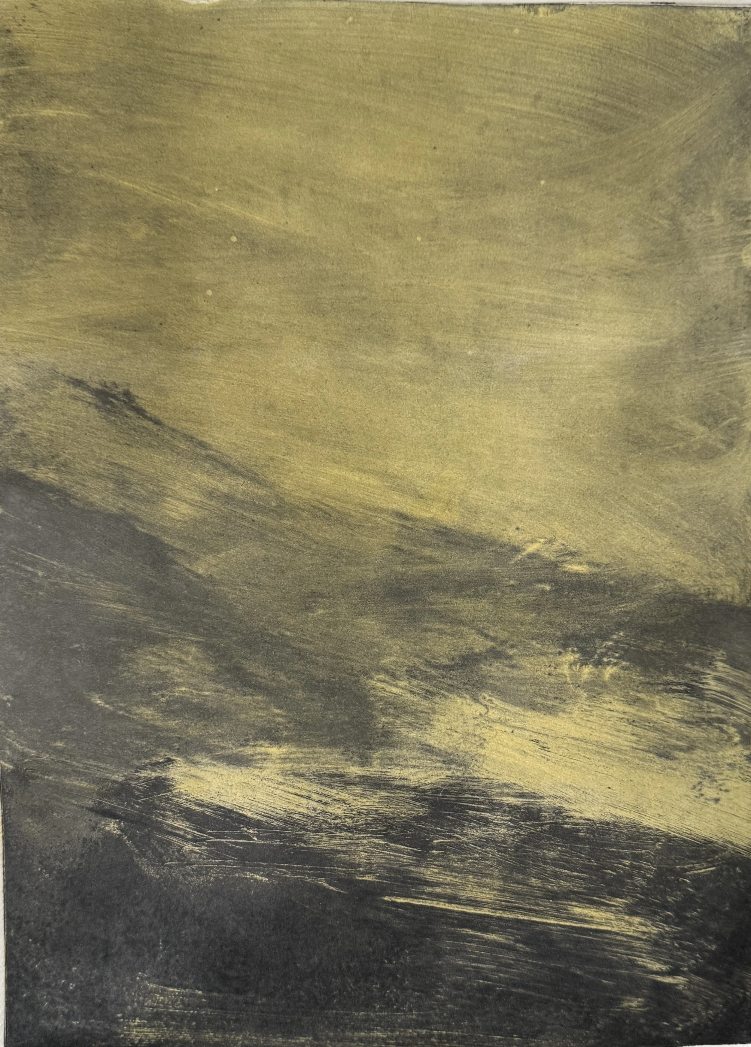 Close-up of a wooden surface painted in black and gold, with the gold paint brushed in streaks across the black background.