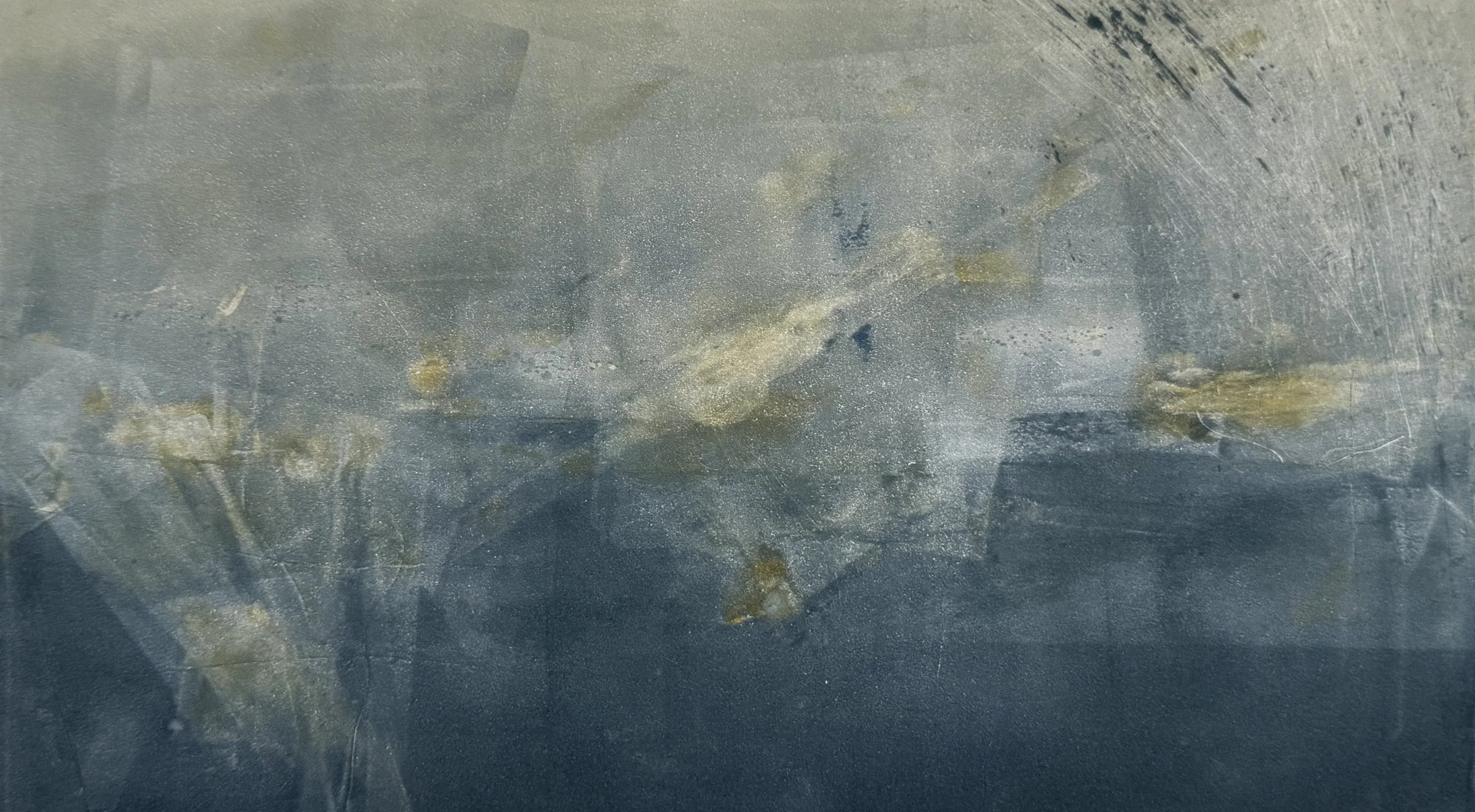 Close-up of a weathered metallic surface with scratches and patches of rust.