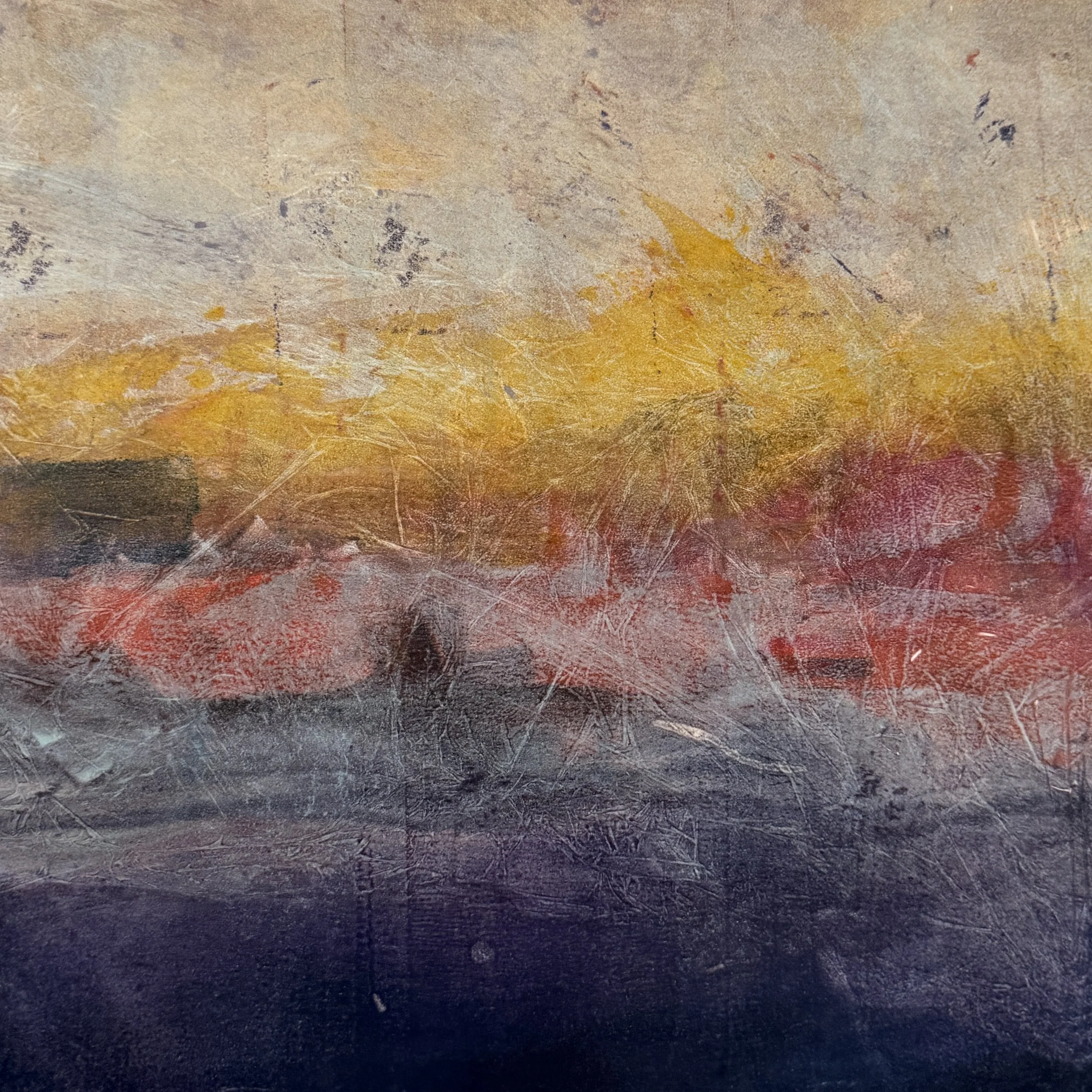 Close-up view of a textured, multicolored surface featuring shades of beige, orange, red, gray, and black with scratches and markings.