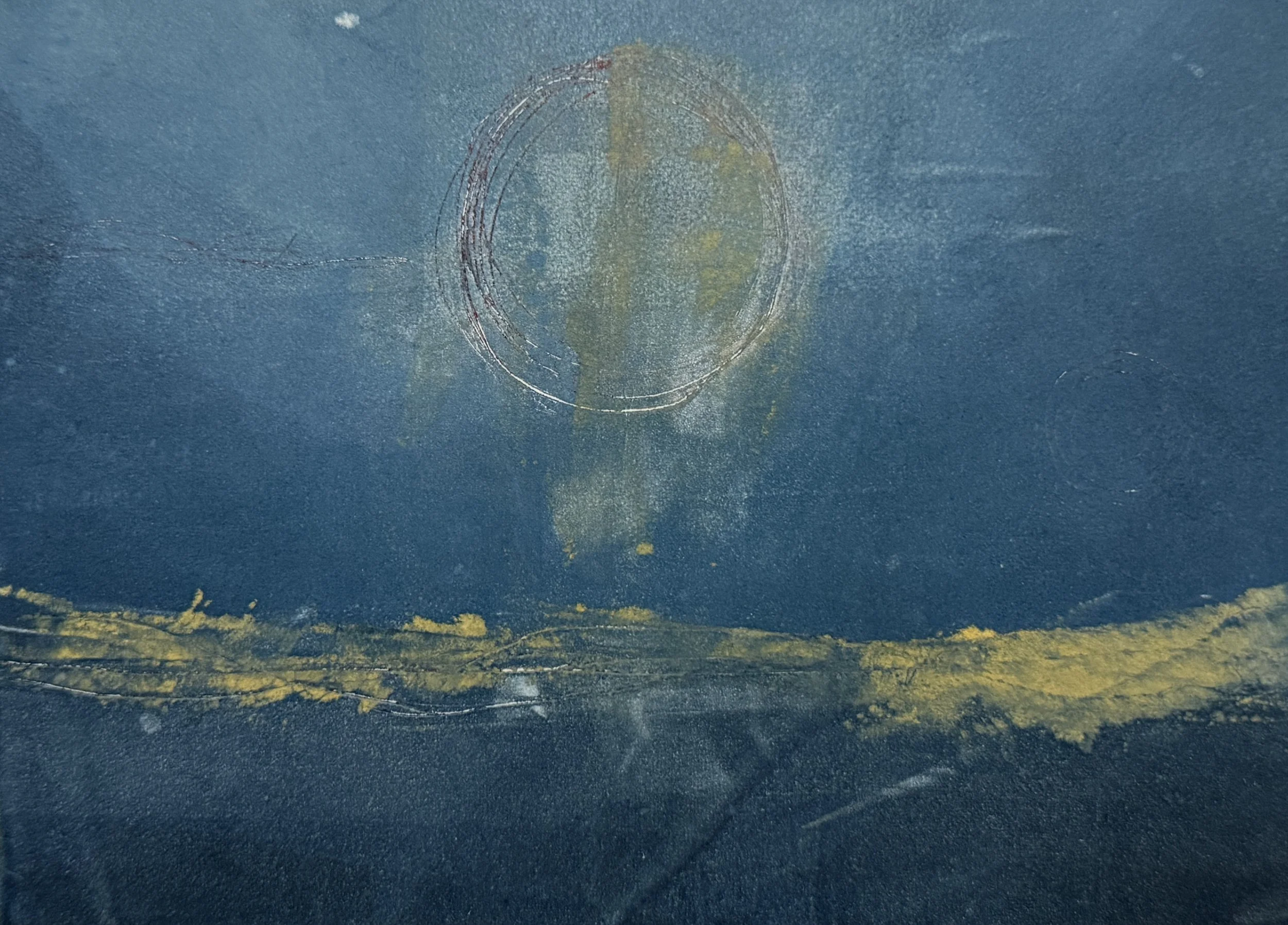 Close-up of a blue surface with a rough texture, featuring a faint circular pattern or marking in the center and yellow accents along the bottom edge.