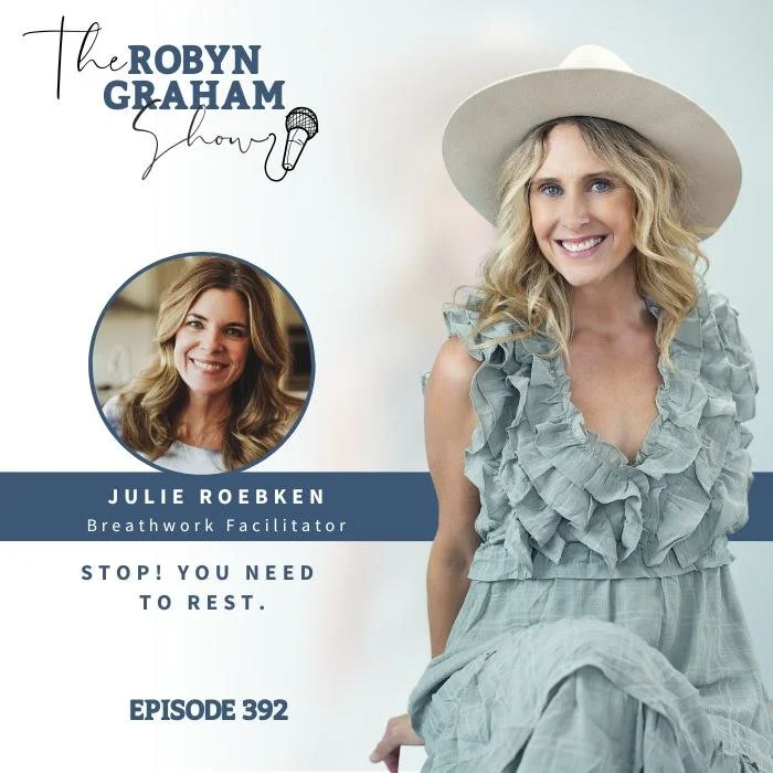 Promotional graphic for The Robyn Graham Show featuring Julie Roebken, a breathwork facilitator, with a woman in a wide-brimmed hat in a ruffled dress smiling while sitting, and a photo of Julie Roebken in a circle, with text including Episode 392 and a quote 'Stop! You need to rest.'