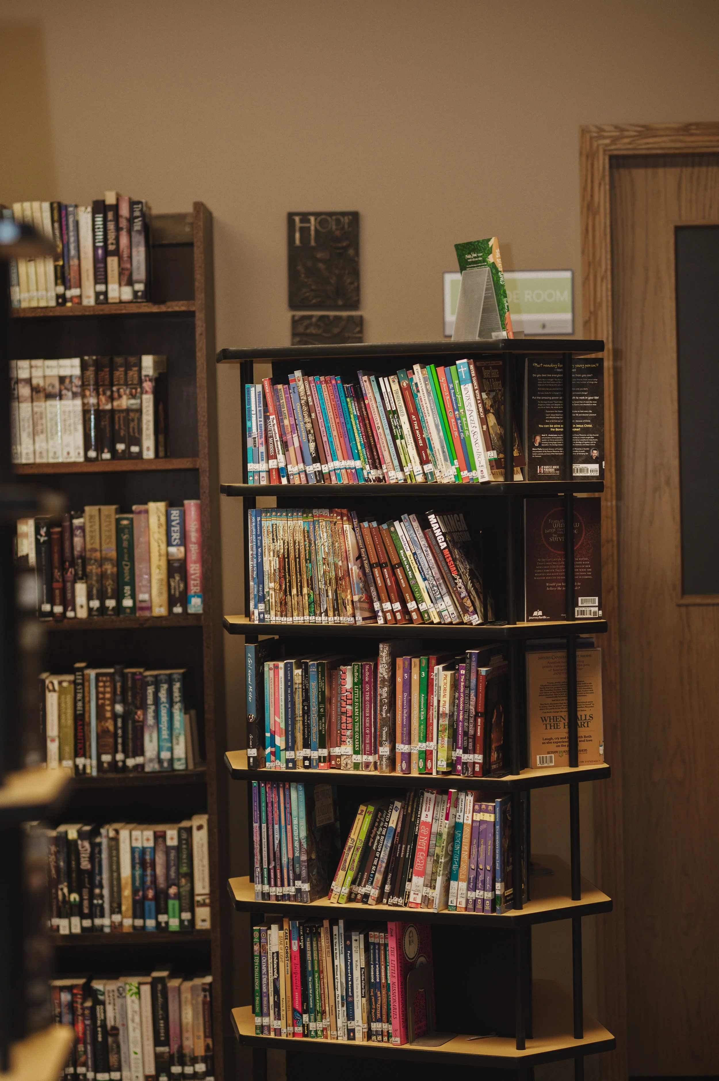 Bookshelves filled with colorful books in a library.