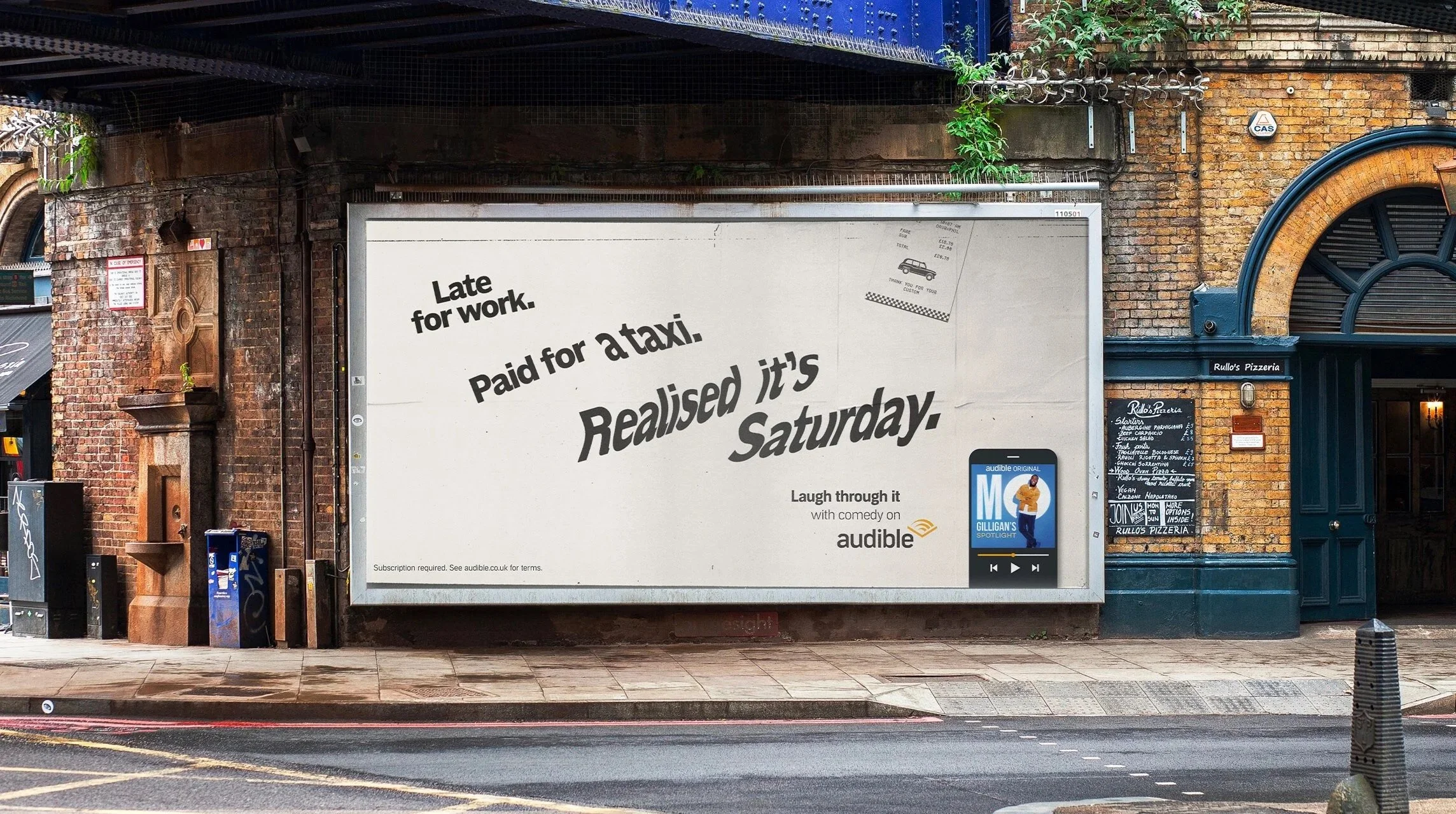 A large white billboard on a brick building wall with the text "Late for work. Paid for a taxi. Realized it's Saturday." Includes a small image of a taxi and a phone screen showing a podcast titled 'Gilligan's Spotlight'. Next to the billboard is a r
