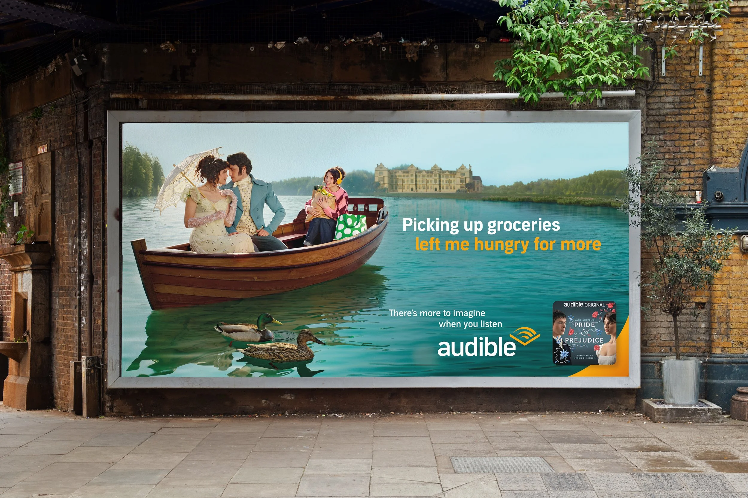 Billboard featuring a romantic scene of a man and woman on a boat by a lake, with a woman holding groceries and a goose on the water. The billboard promotes Audible audiobooks, with some book titles visible at the bottom.