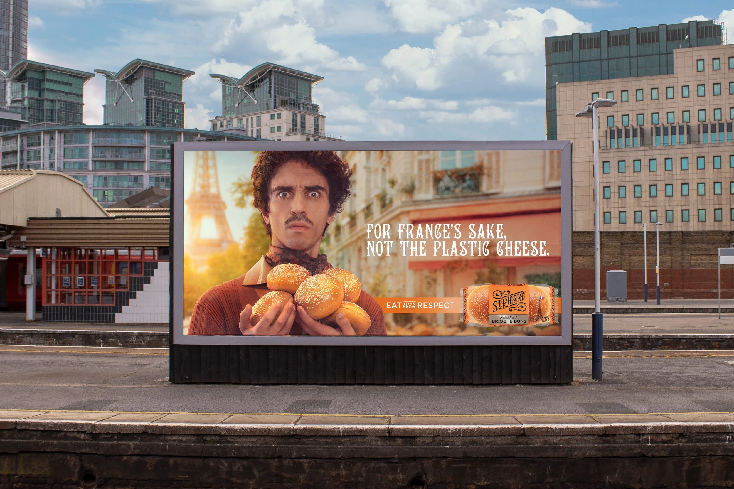 Billboard advertising seeded brioche buns with a man holding a bun in front of the Eiffel Tower in the background.