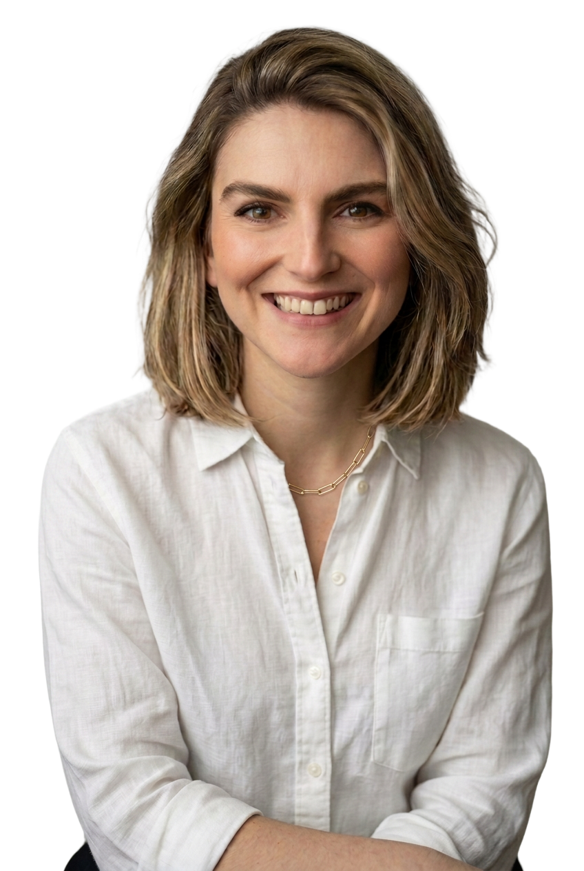 A smiling woman with shoulder-length blonde hair wearing a white button-up shirt and a gold necklace.