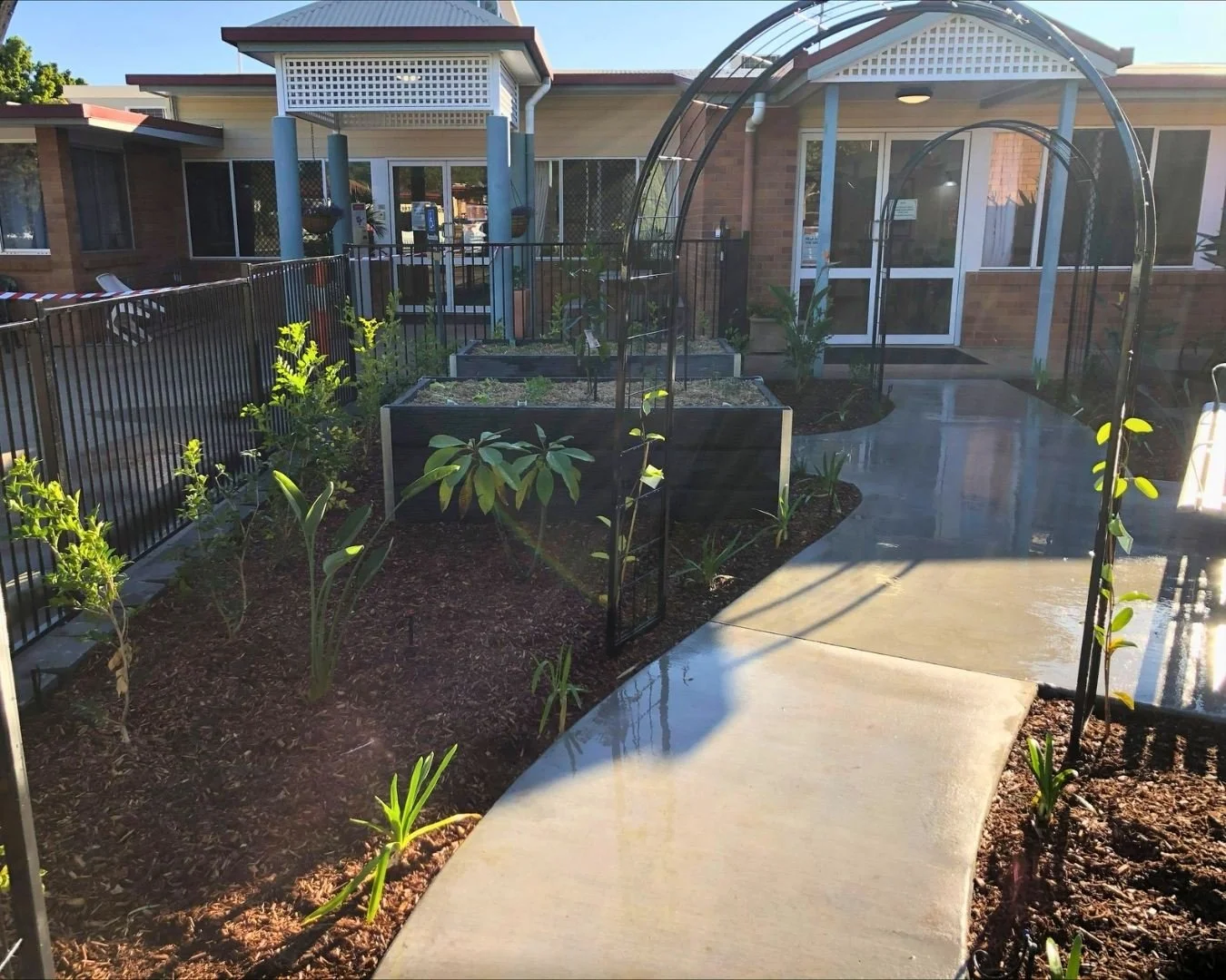 concrete garden path,  gardens with mulch finishing