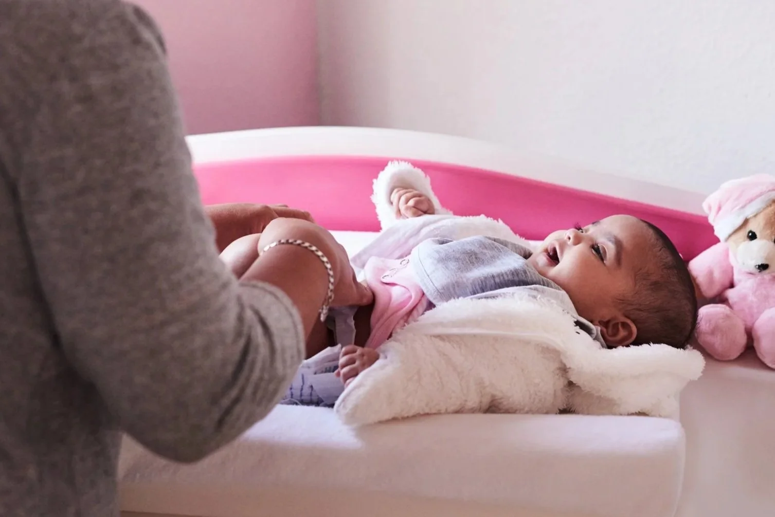 Infant care with baby getting changed.