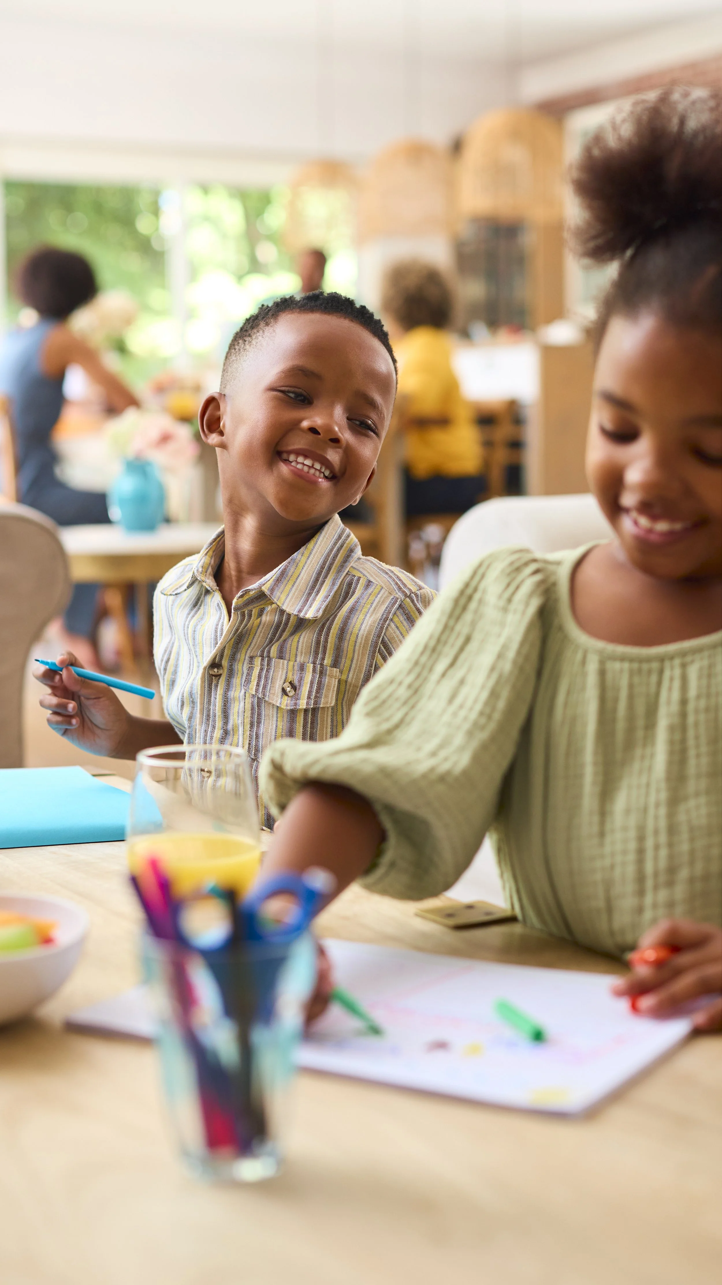 Preschool age children happy at table.