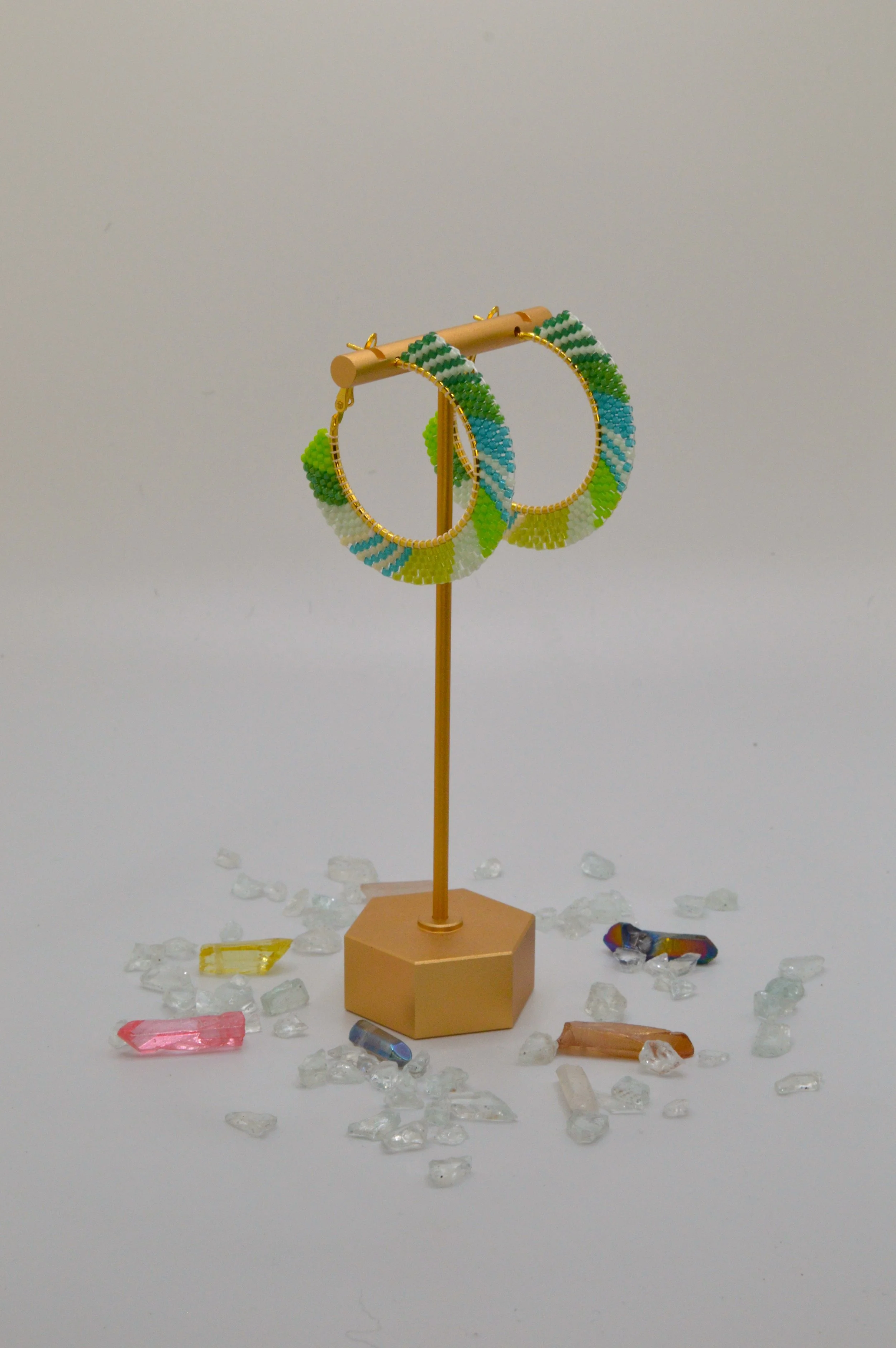 Green, teal, white and lime seed bead woven hoop earrings in gold-tone metal.