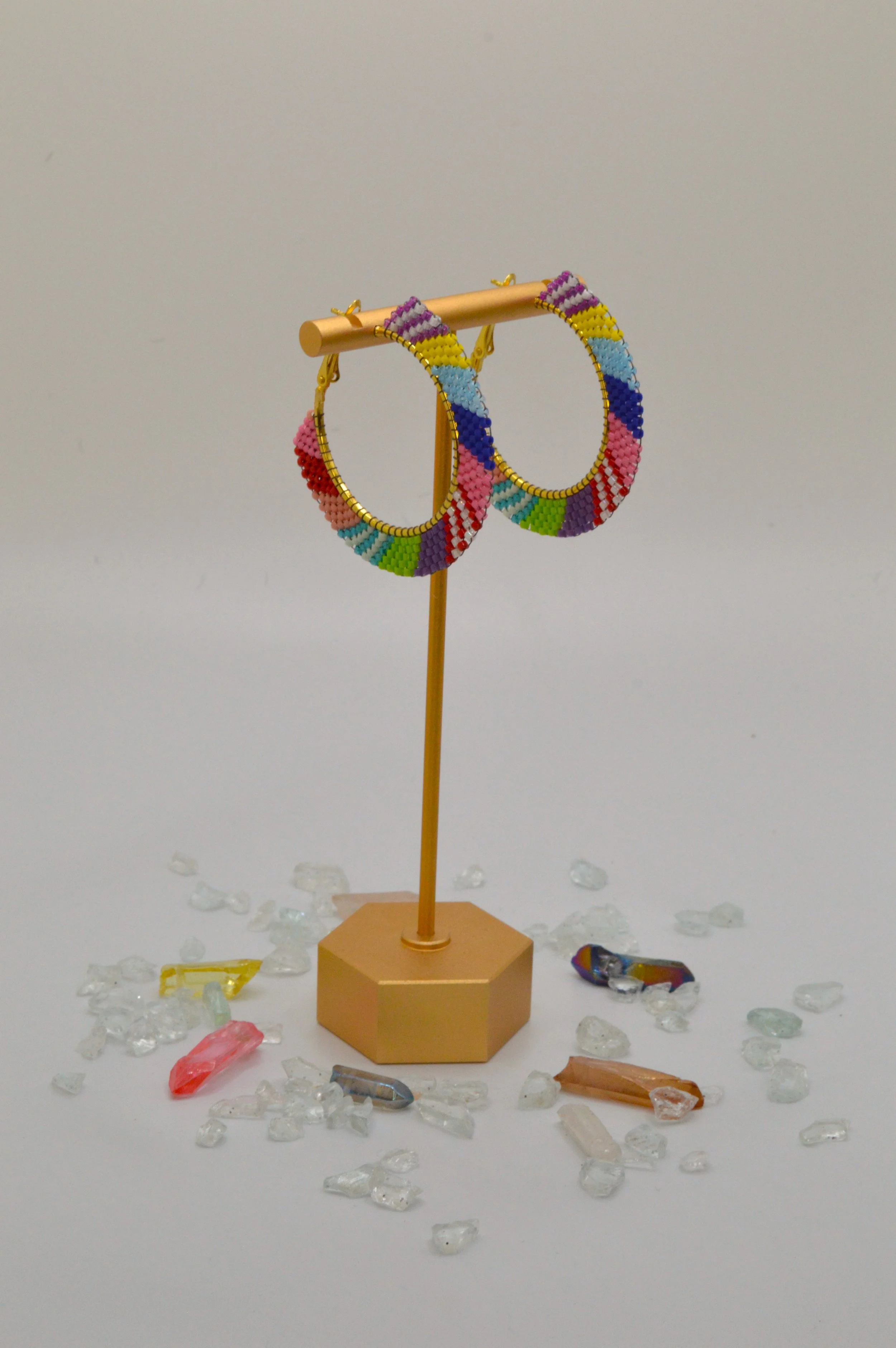 Multicolor colorblock seed bead woven hoop earrings in gold-tone metal.