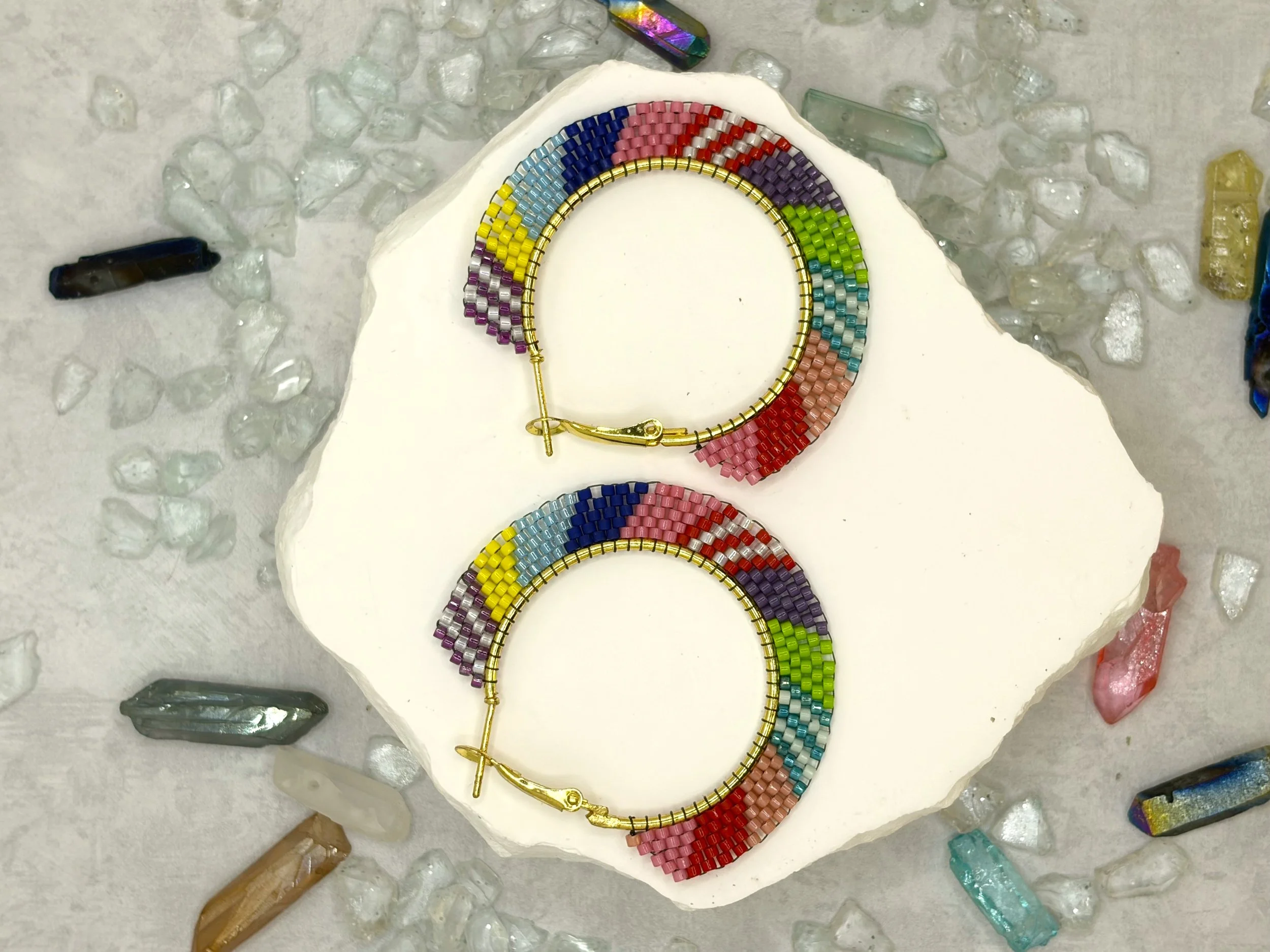 Multicolor colorblock seed bead woven hoop earrings in gold-tone metal.