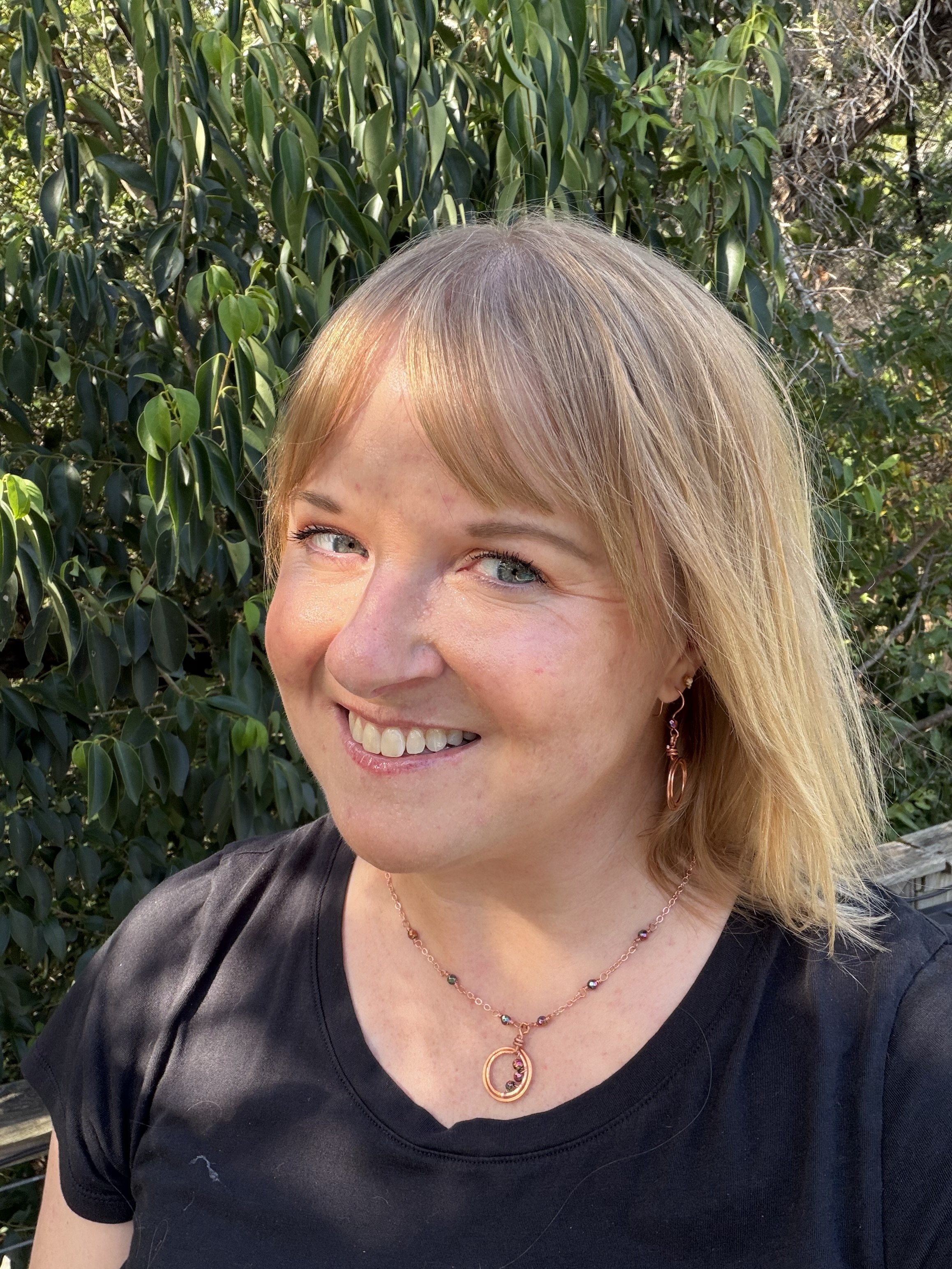 woman wearing handmade copper chain necklace with hematite beads and hammered double loop pendant (Copy)