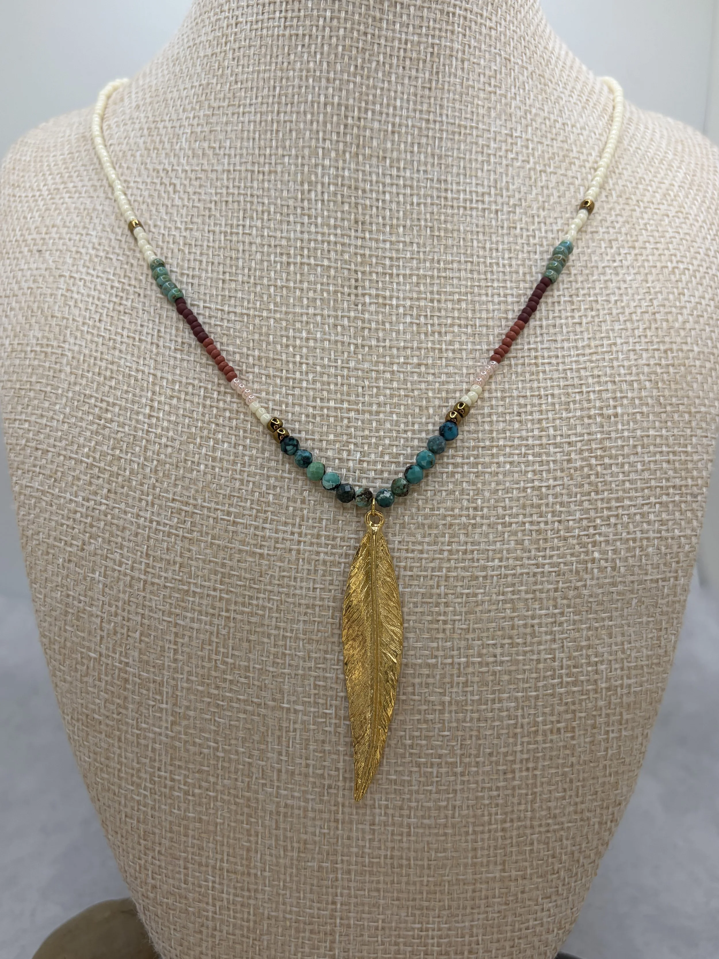 handmade seed bead necklace with turquoise beads and gold stainless steel feather pendant