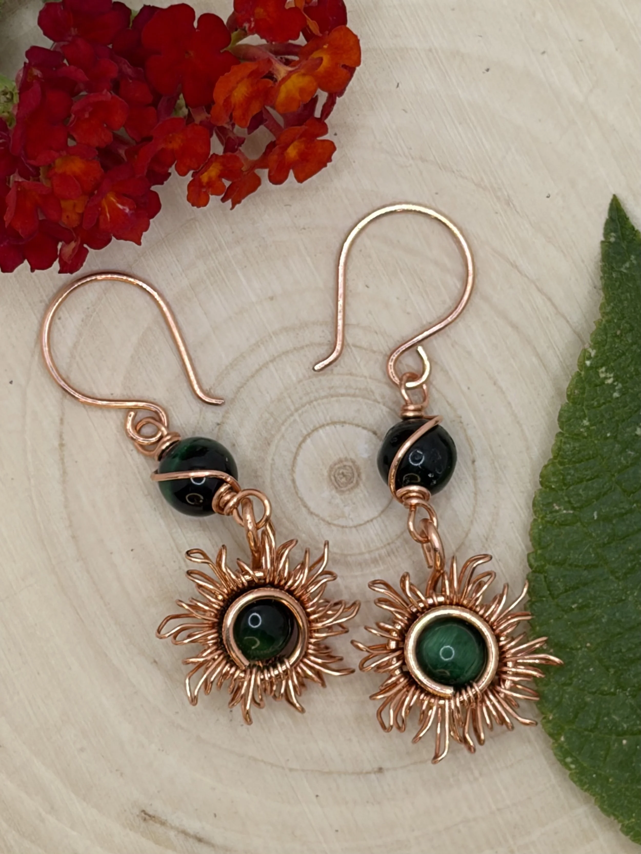 Handmade copper sunburst earrings with dark green tiger's eye stones