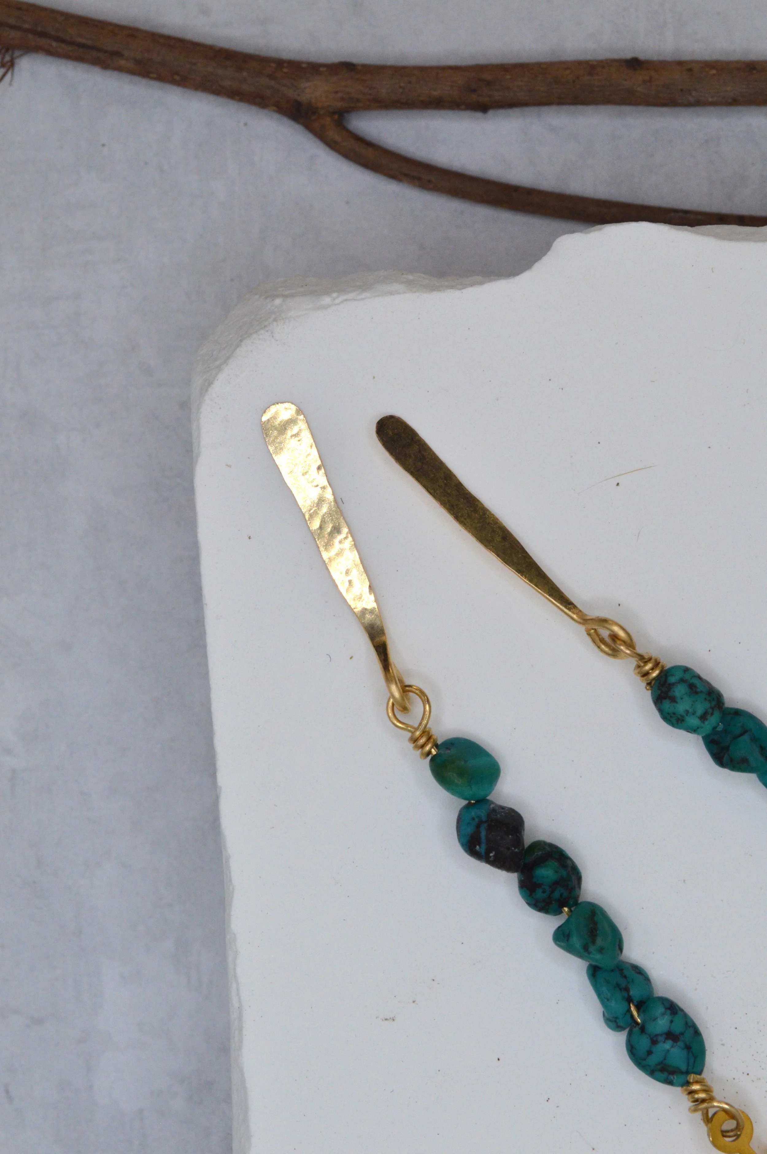 handmade turquoise nugget earrings with brass sunburst charm and hammered gold drop