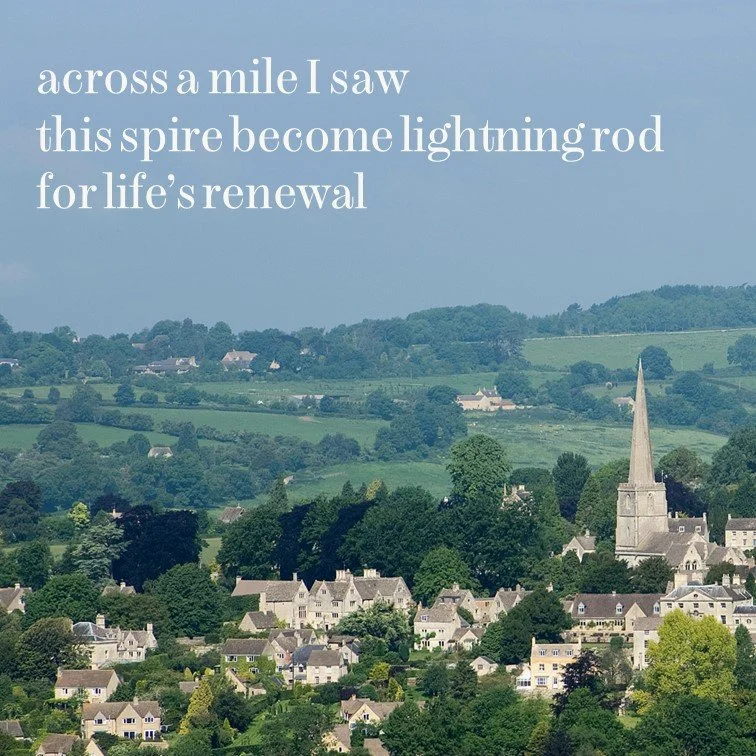 A scenic view of a small town with numerous houses and a church with a tall steeple, surrounded by lush green hills under a cloudy sky. Overlaid text reads: 'across a mile I saw this spire become lightning rod for life’s renewal.'