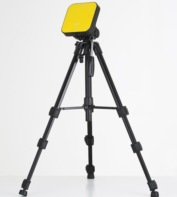A continuous radon monitor mounted on a tripod attached to the top, set against a plain white background.