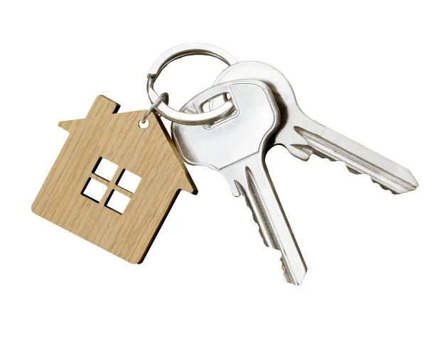 Keys attached to a keyring with a house-shaped keychain.