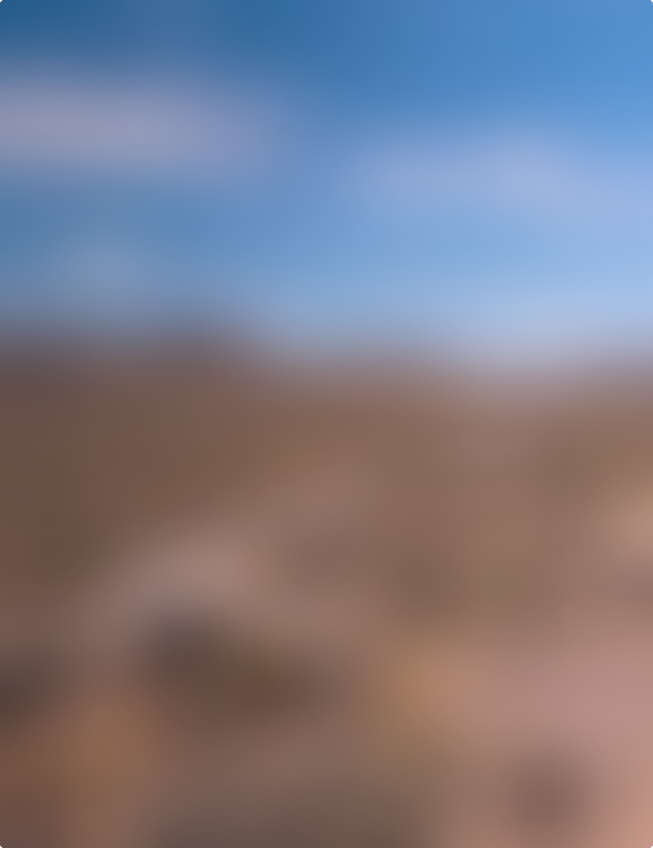 The image is blurred and indistinct, showing a mix of blue, brown, and beige colors without clear objects or details.