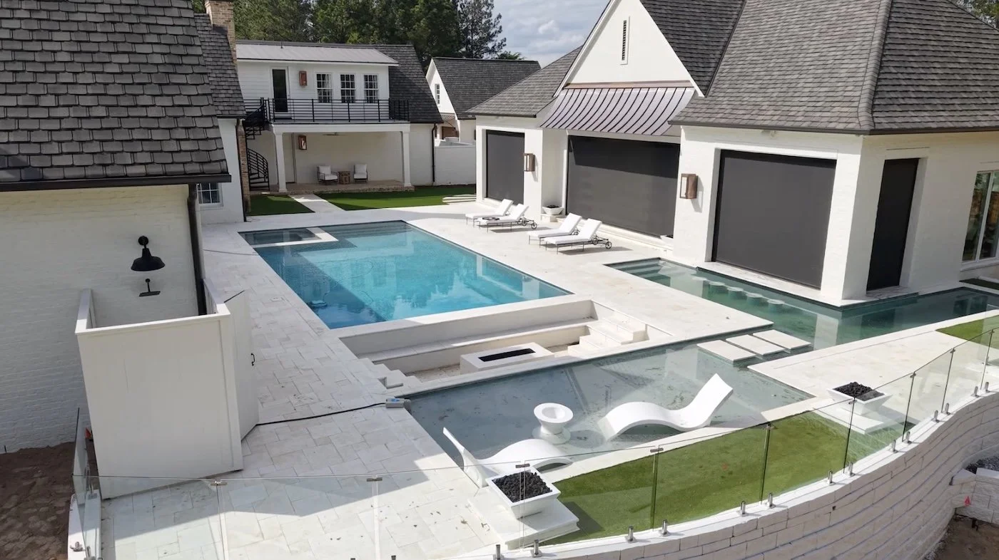 Finished residential pool surround with hardscape and planting