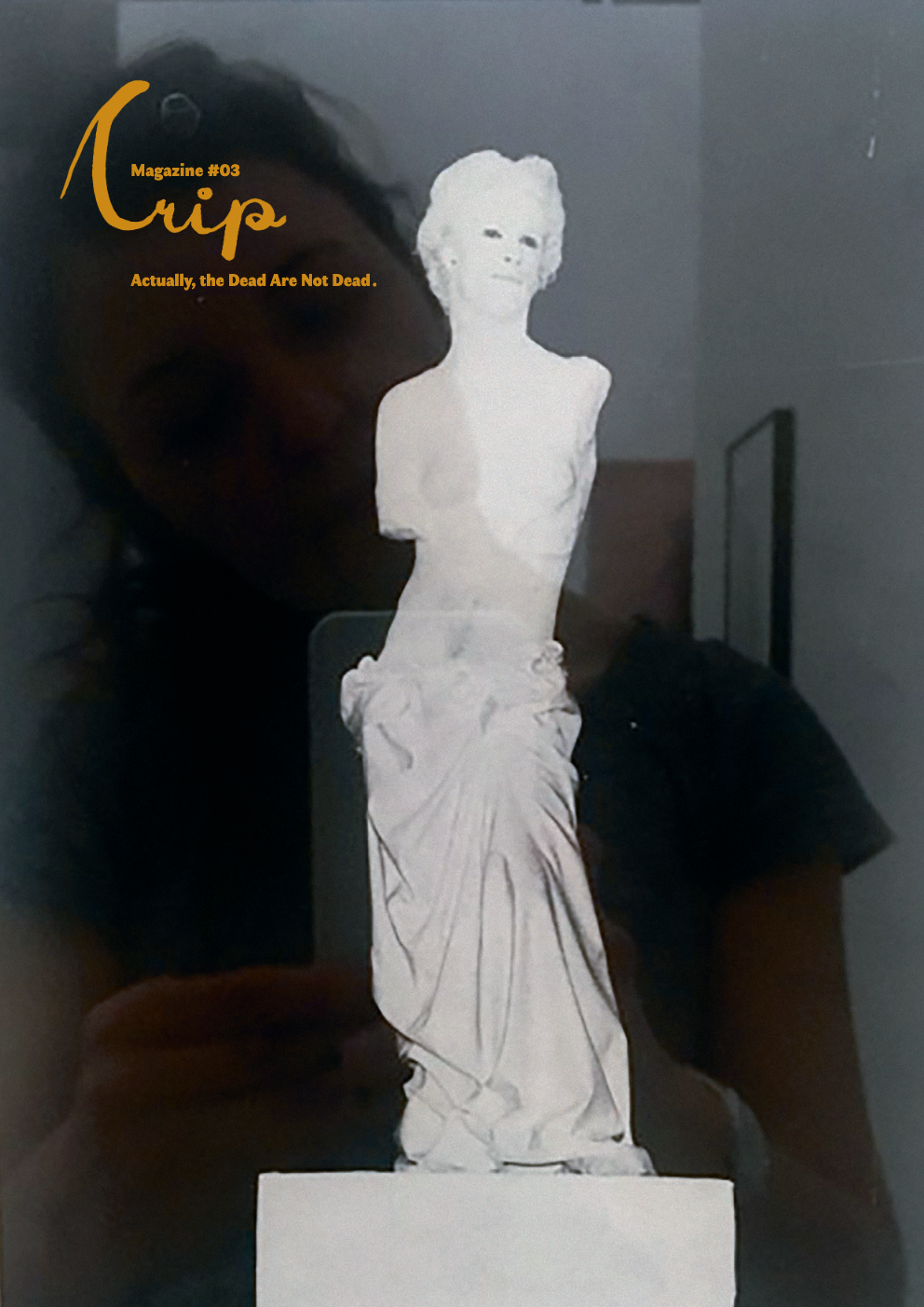 A person holding a white paper cutout of a classical statue with the magazine title 'Cusp' and the tagline 'Actually, the Dead Are Not Dead.'