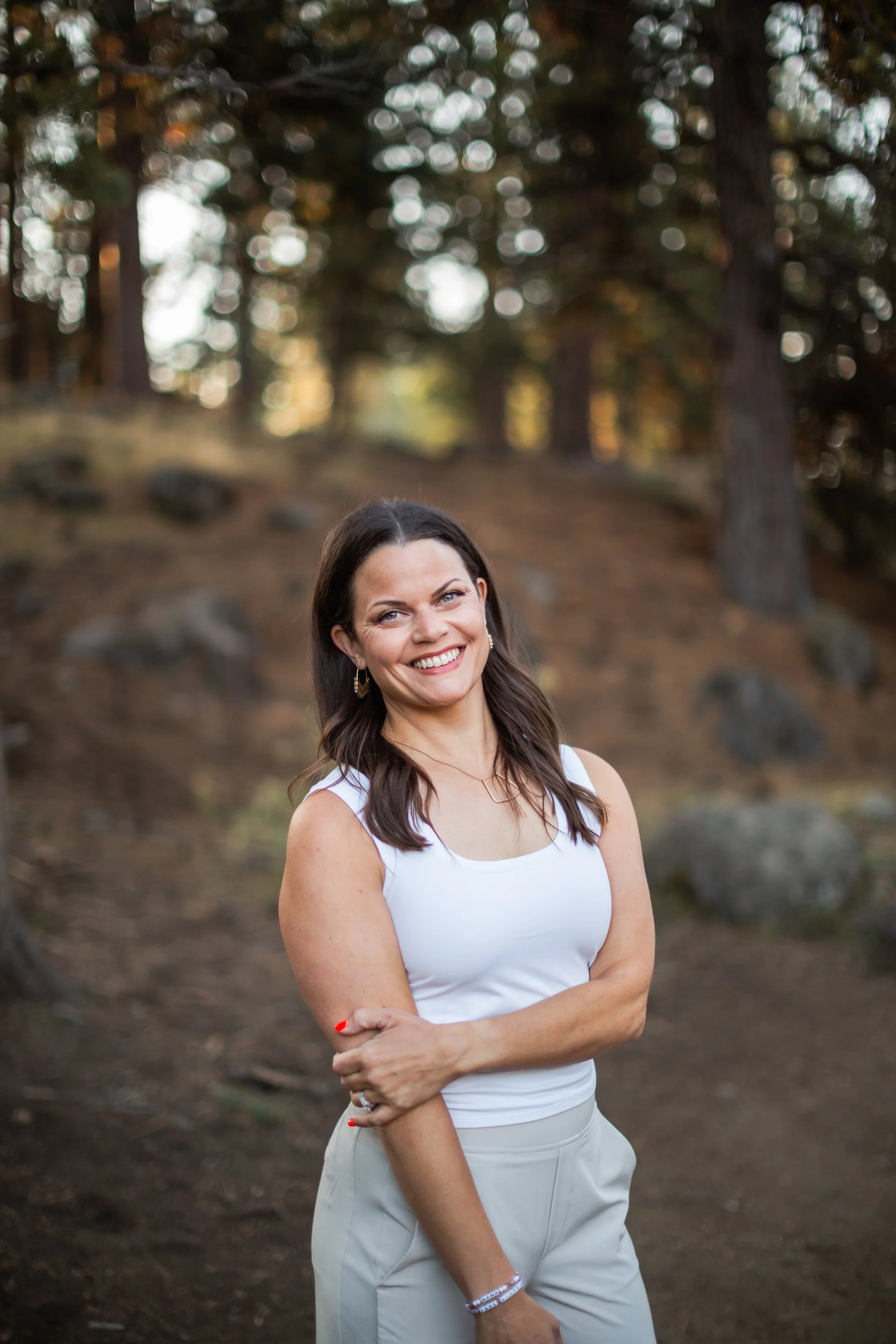 Angie Watson outdoors in a wooded landscape in Bend, Oregon.