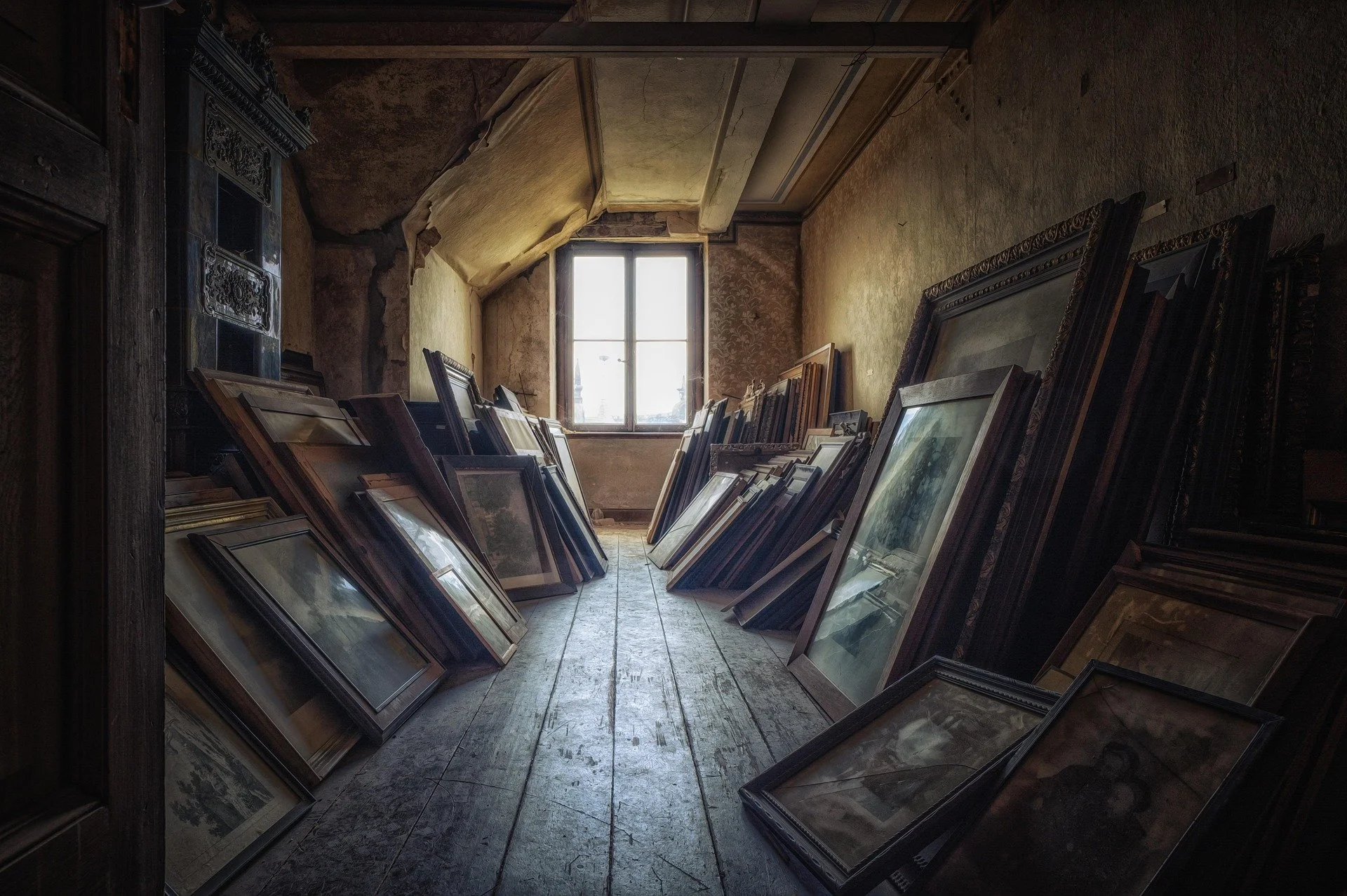 Old attic with many pieces of antique framed art
