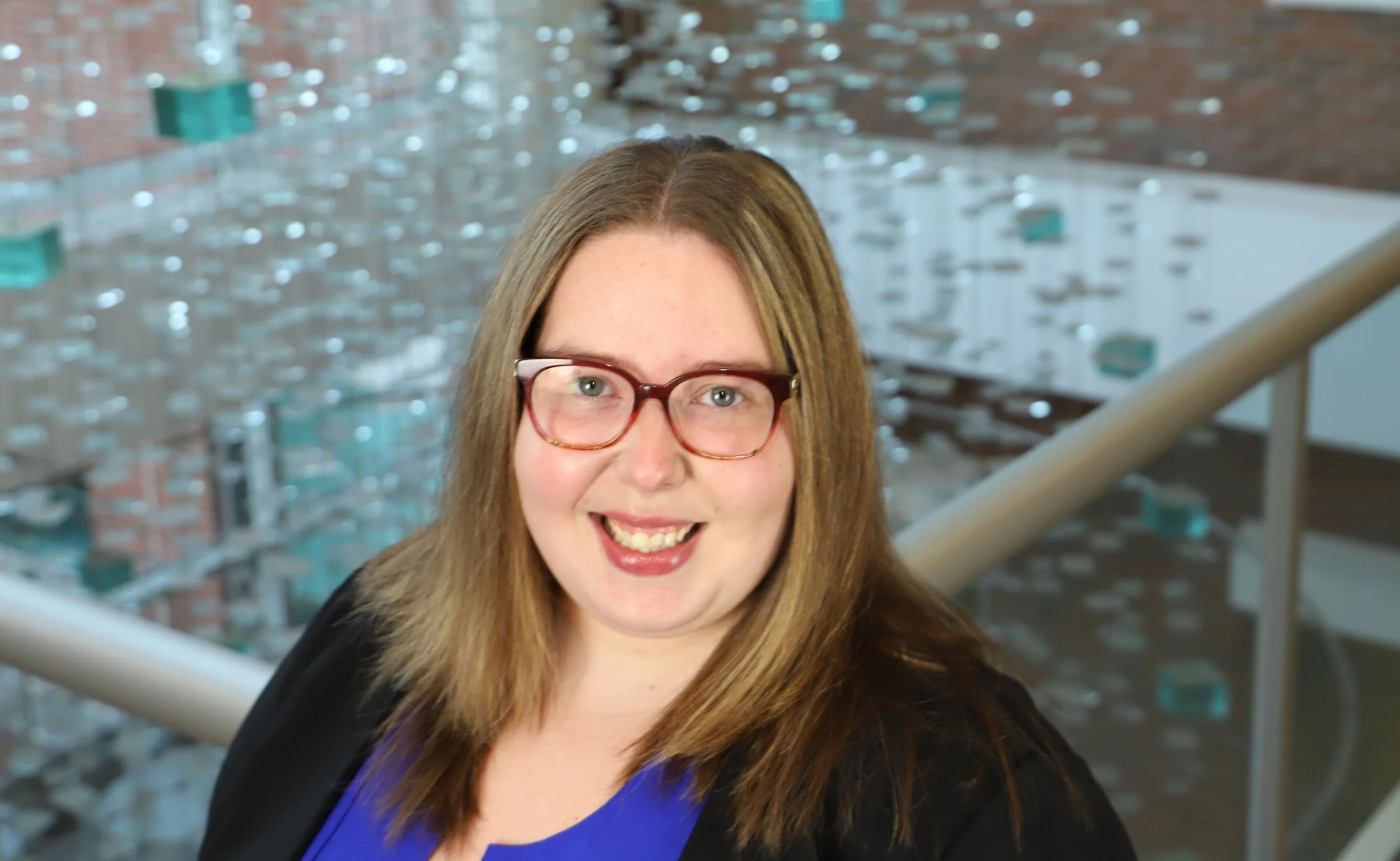 Kristen D. Krause, the Assistant Professor of the Department of Urban-Global Public Health at the Rutgers School of Public Health, Deputy Director of the Center for Health, Identity, Behavior and Prevention Studies (CHIBPS), standing inside.
