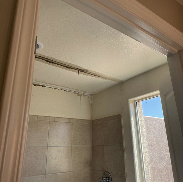 Shower running as ceiling water stain spreads