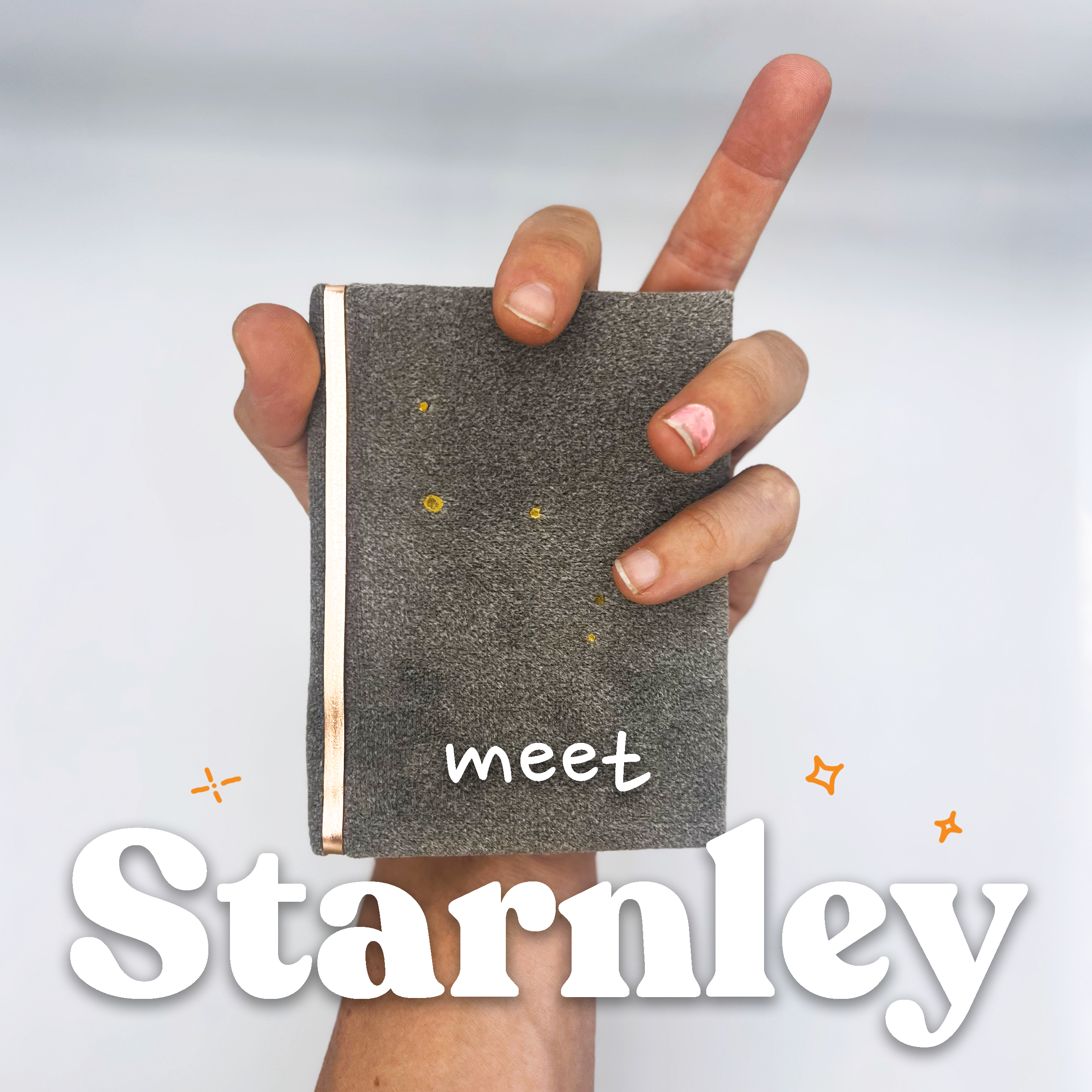 A hand holding a gray poster with the words 'let's meet' written on it.