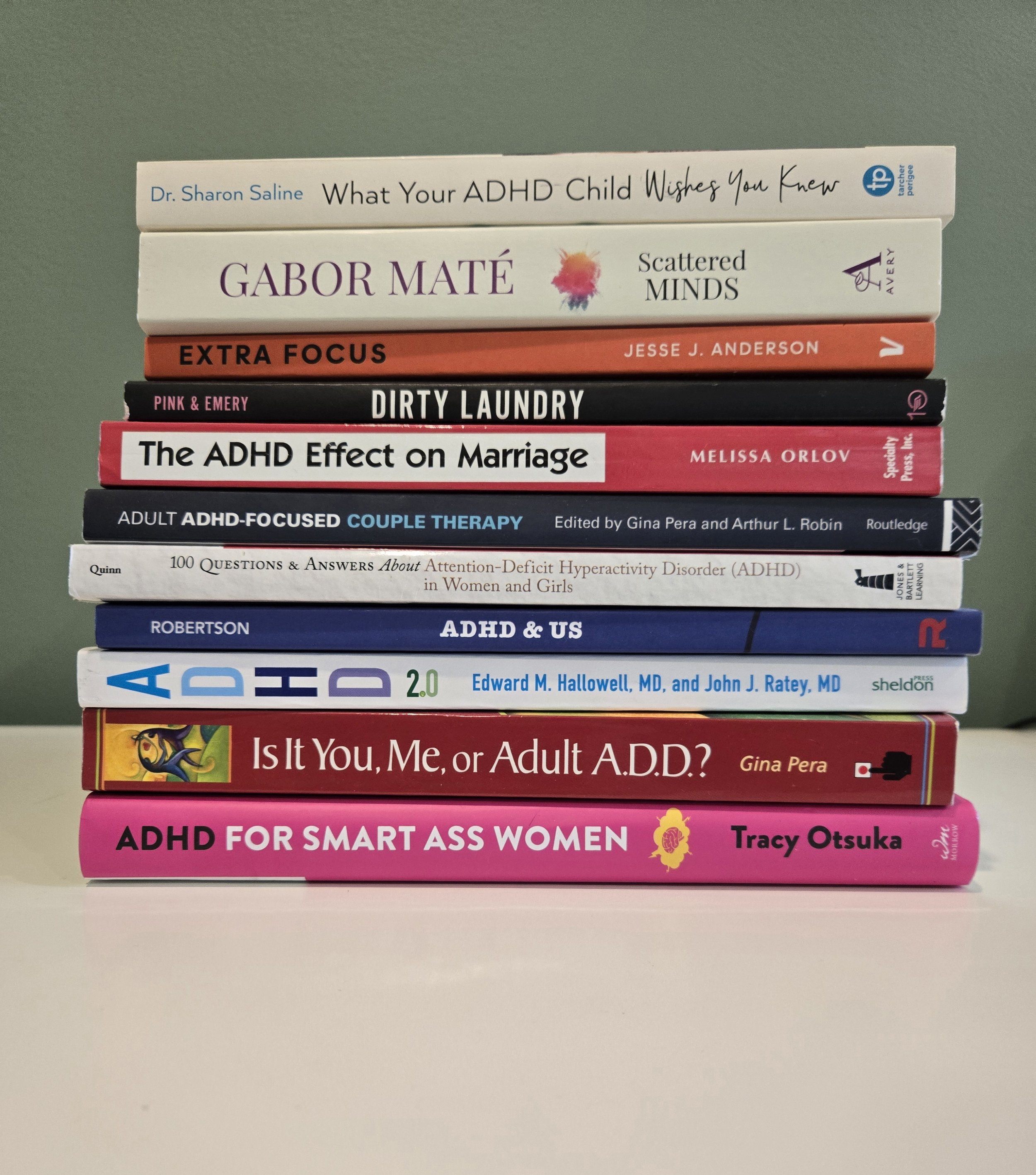 Stack of ten books about ADHD and mental health, with titles visible.