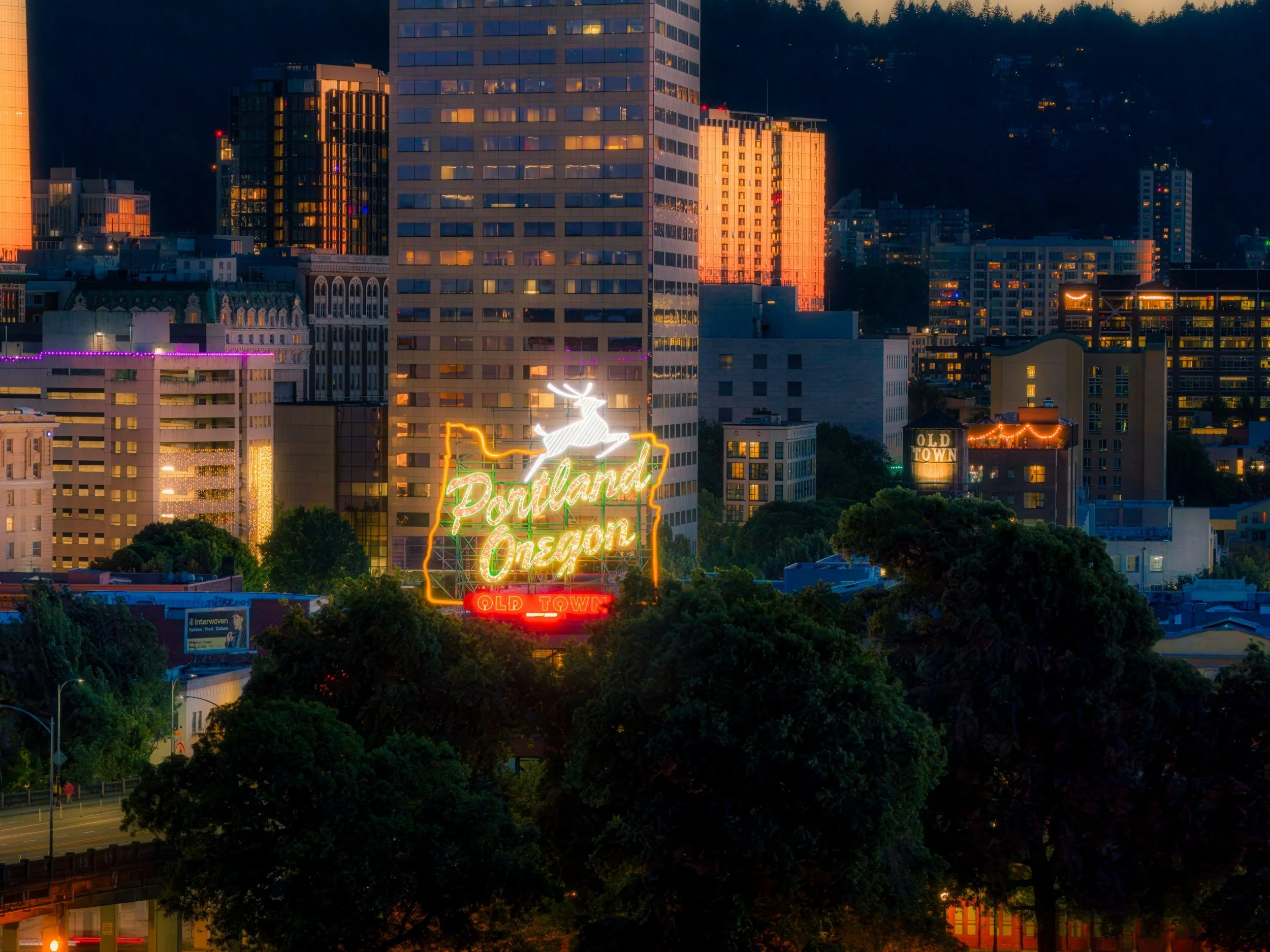Portland, Oregon skyline at night with the illuminated Portland Oregon sign