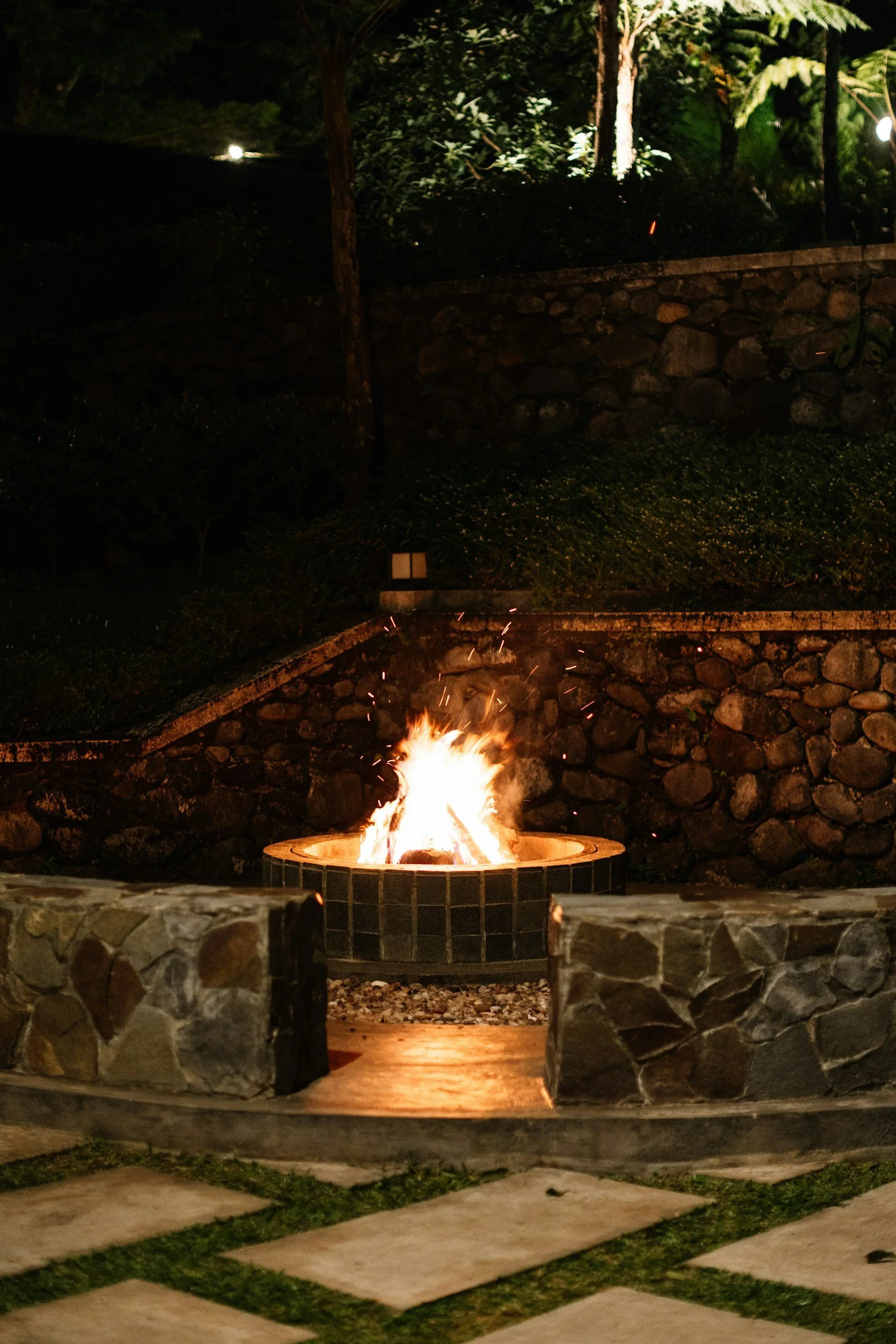 Outdoor living space featuring a stone fire feature, custom hardscaping, and a comfortable gathering area surrounded by landscaping. Aqua Terra Pool and Patio creates thoughtfully designed outdoor spaces throughout Cincinnati.