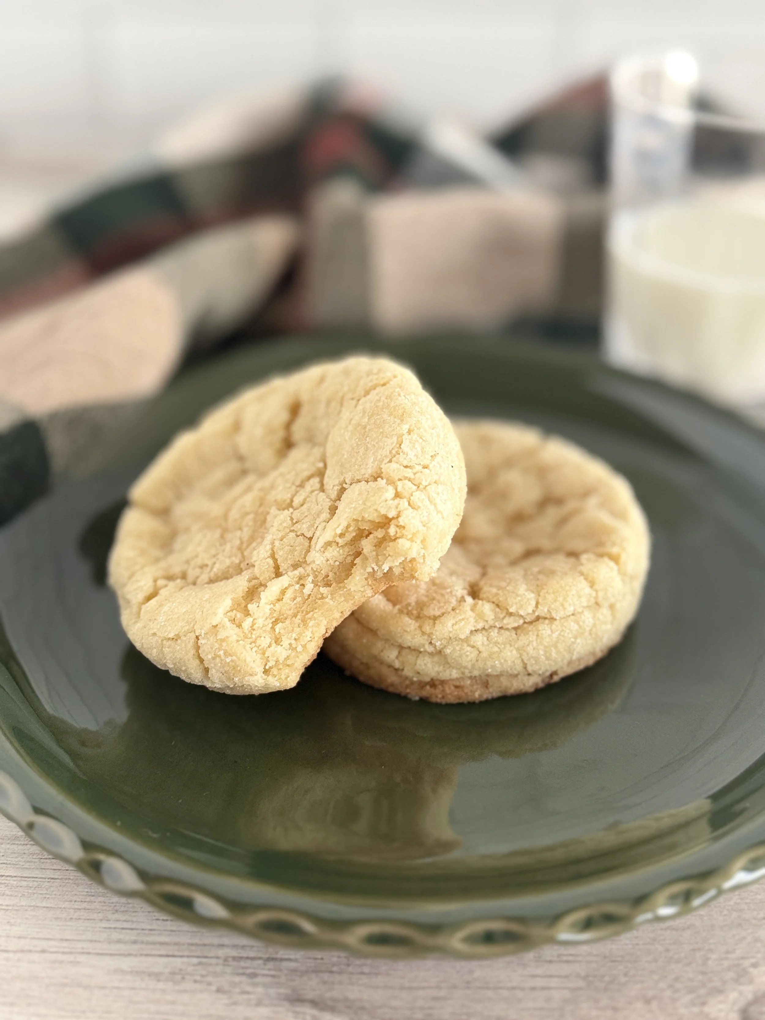 Two sugar cookies on a green plate.