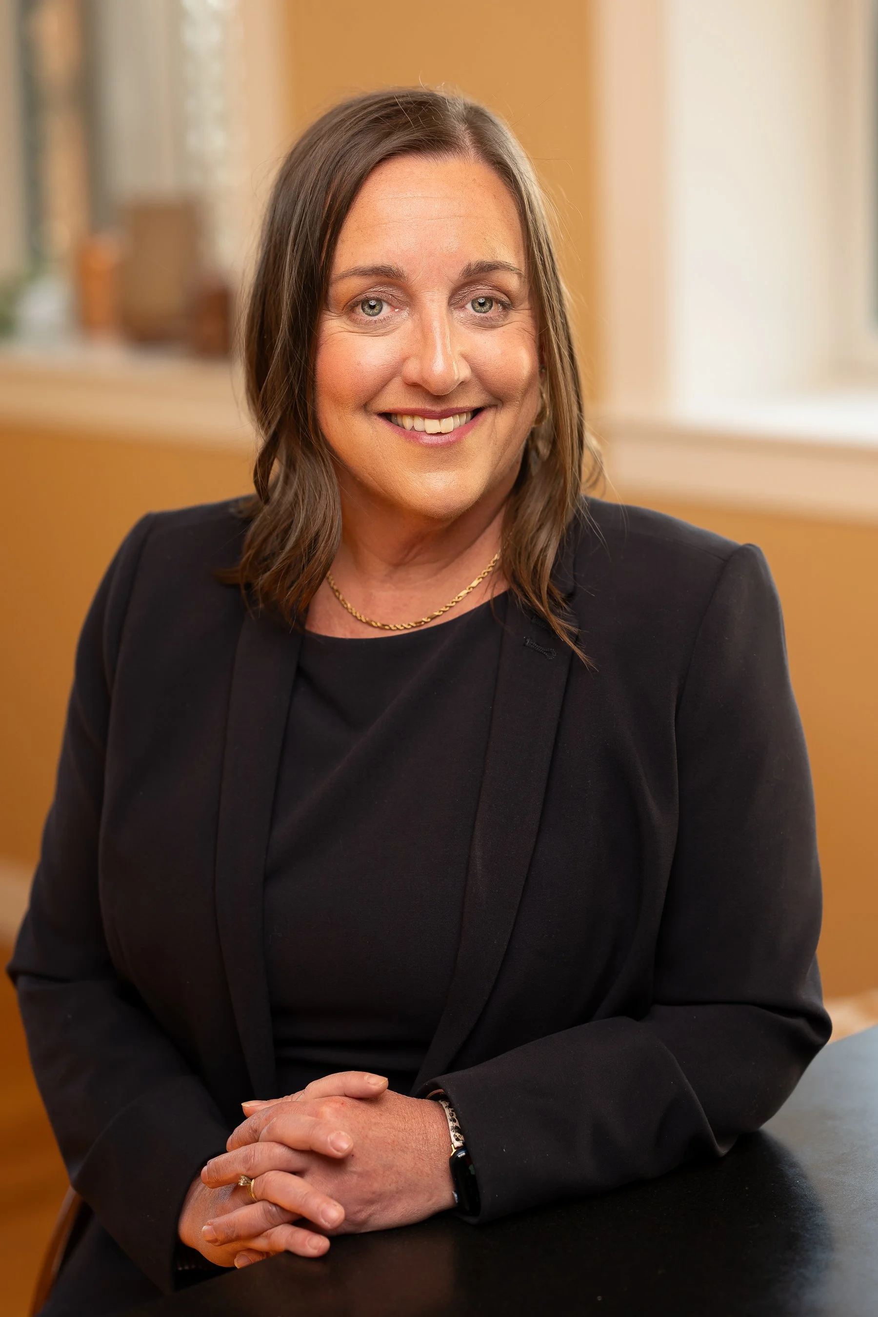 Gloucester attorney Christina Griecci seated in her office at Griecci Law