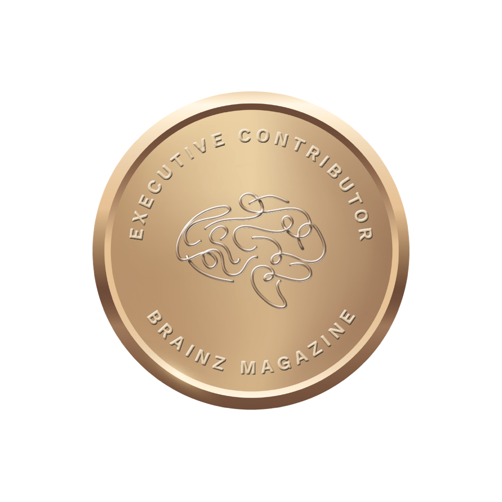 A circular award medal with the words 'Executive Contributor' and 'Brainz Magazine' inscribed around the edge, featuring a stylized brain illustration in the center.