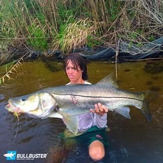 Captain Baylor Bullock holding a 40-inch snook caught in Palm City, Florida, a statewide tournament-winning fish.