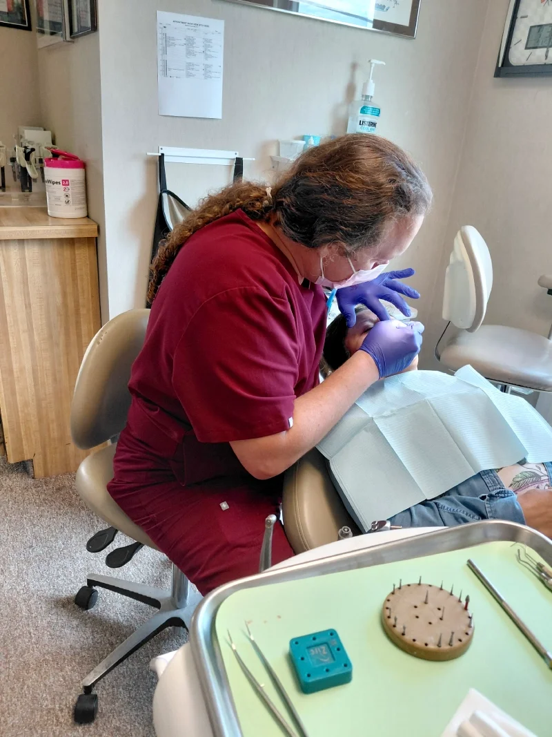 A dentist works with a patient