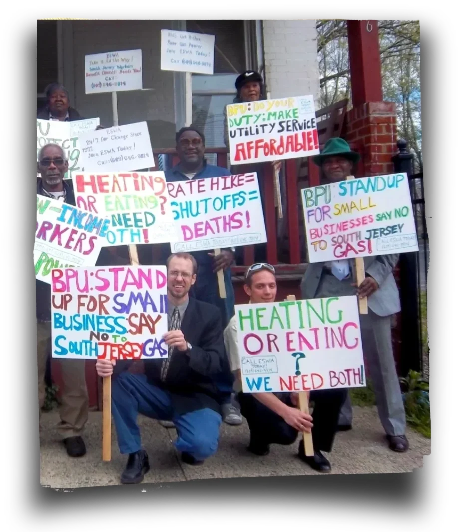 People pose with signs and smile