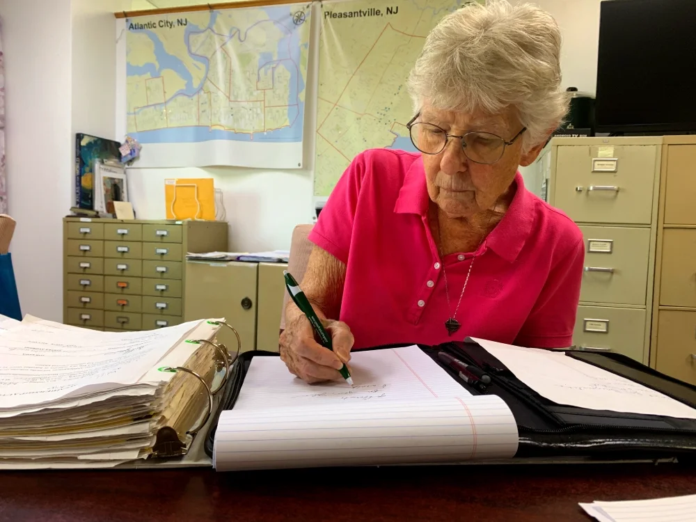 A woman writes on a page