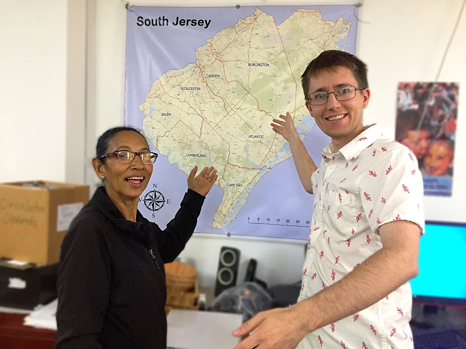 A man and woman gesture to a map of South Jersey