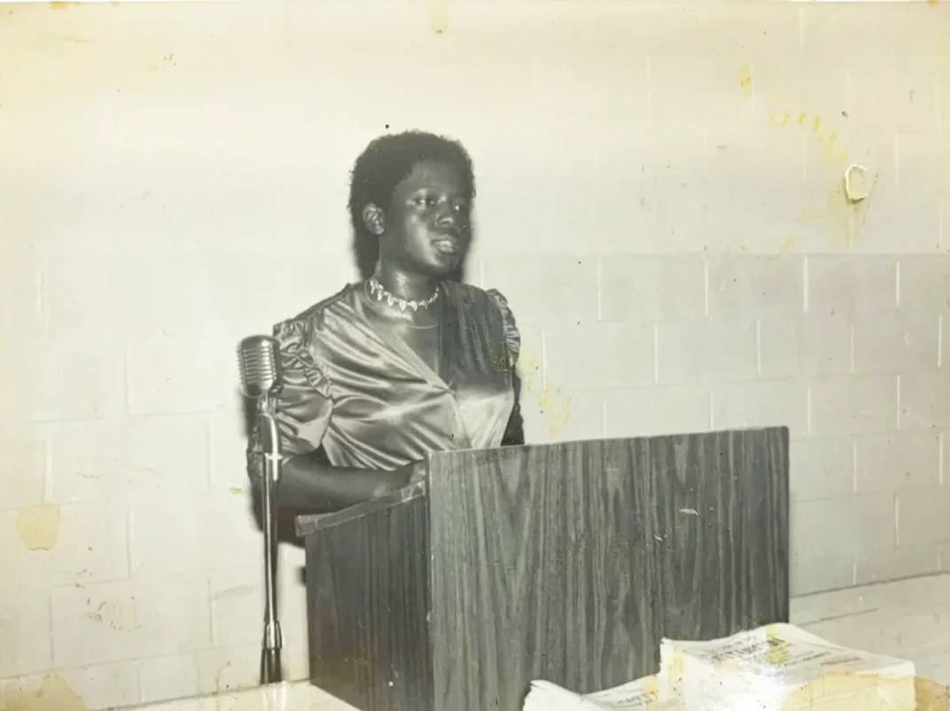 A woman speaks in front of a podium